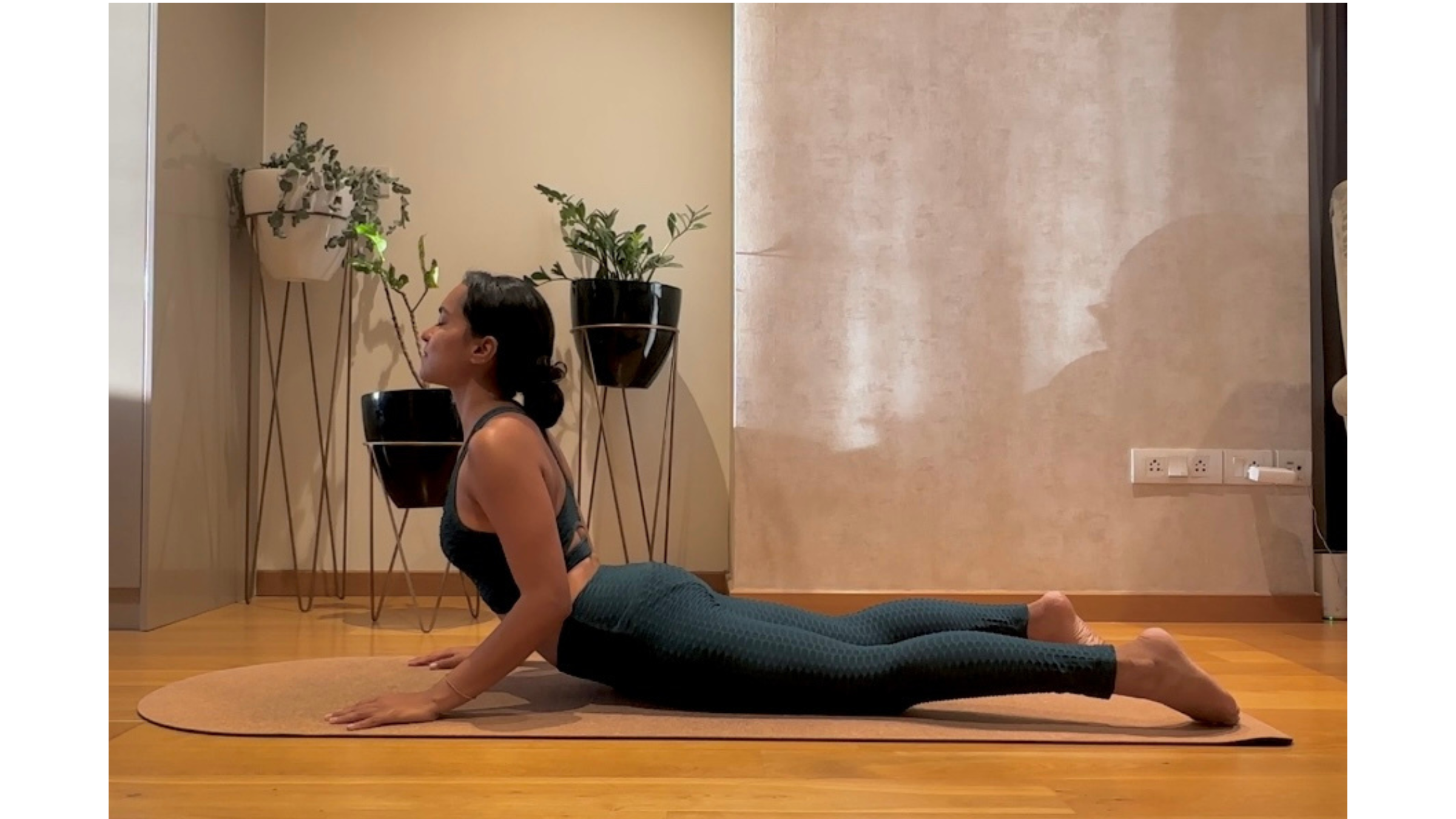 Yoga teacher practicing Cobra Pose.