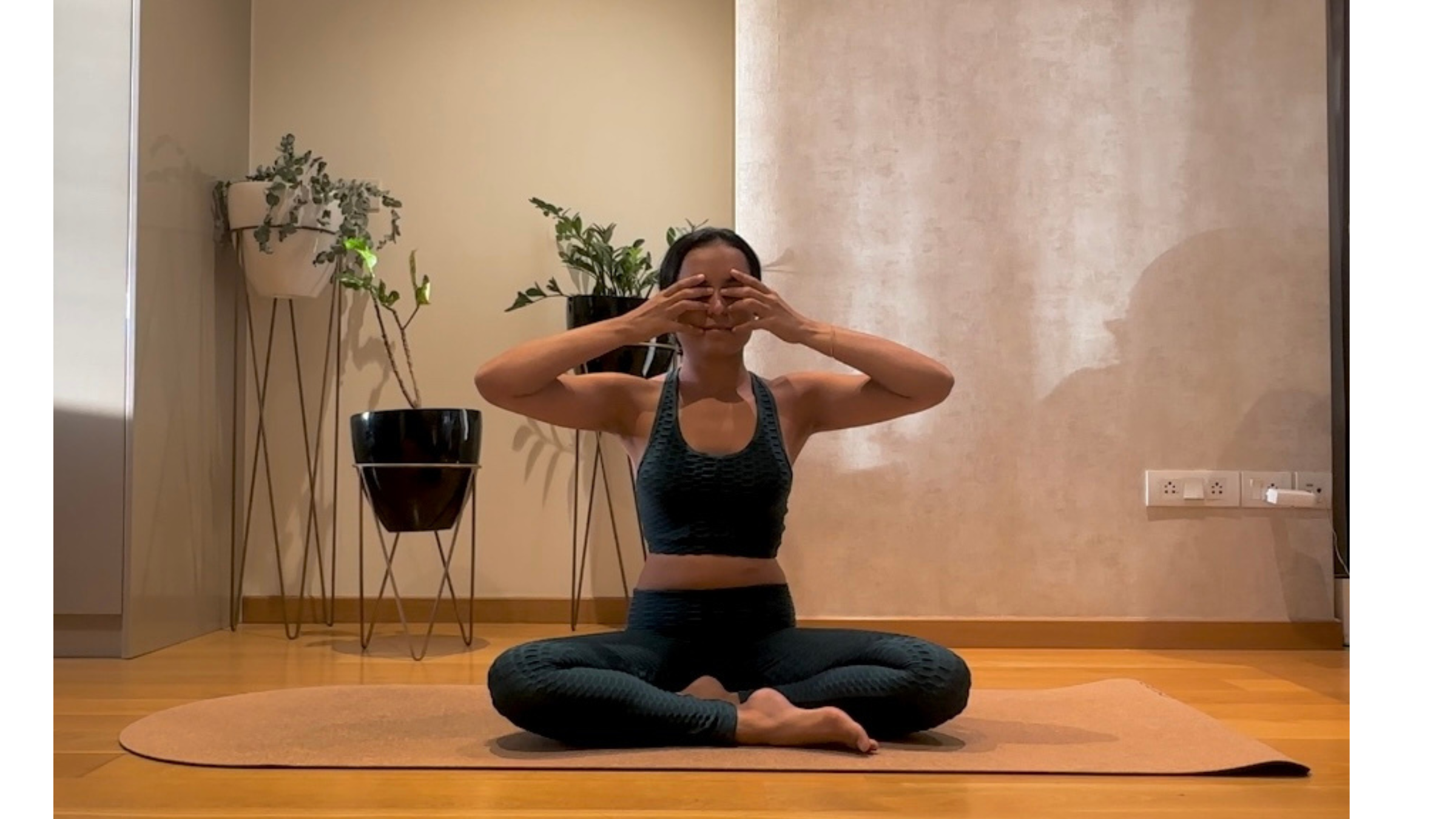 Yoga teacher practicing Bee Breath.