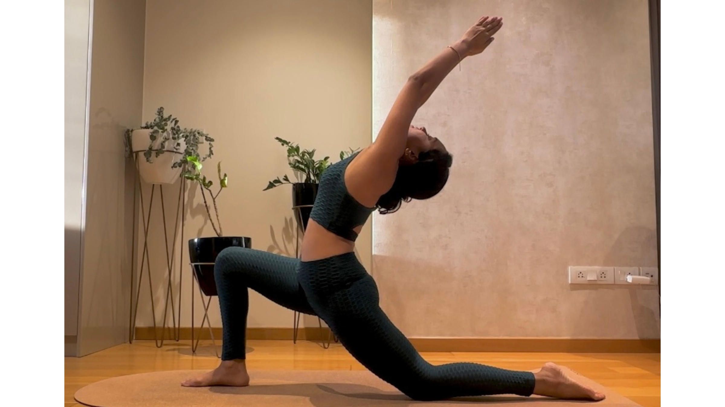 Yoga teacher practicing Low Lunge with backbend.