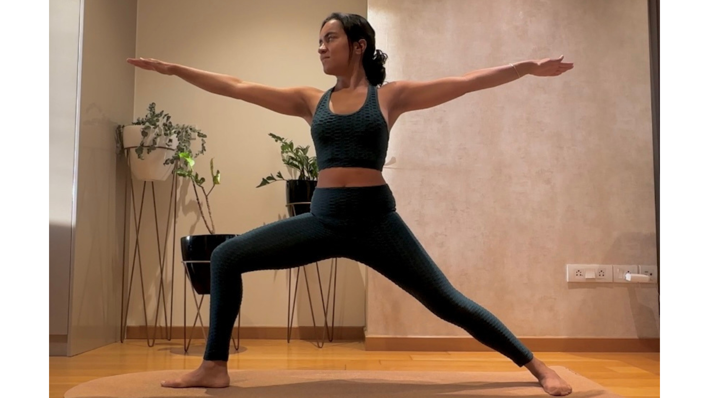 Yoga teacher practicing Warrior 2.