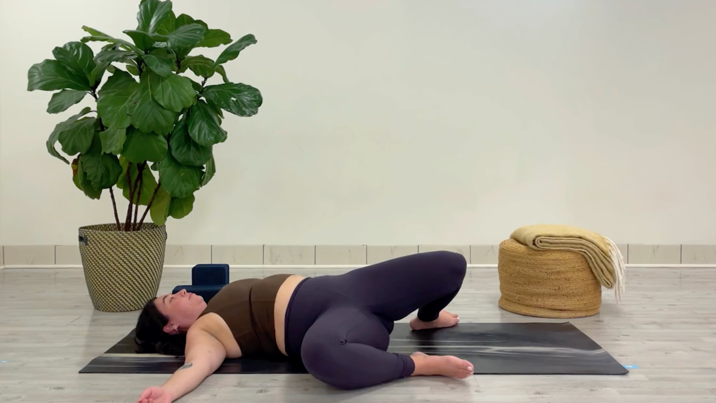 Yoga teacher Taylor Lorenz in Windshield Wipers, one of the best yoga poses for chilling out