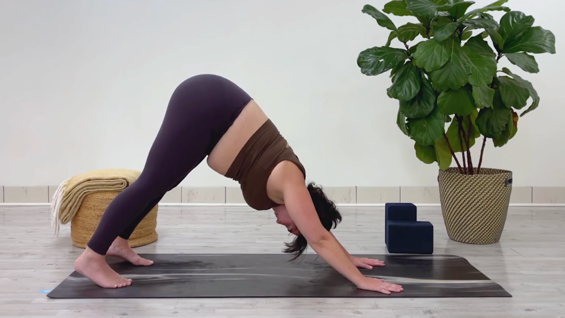 Yoga teacher Taylor Lorenz in Downward-Facing Dog, part of her 10-minute cool down yoga routine