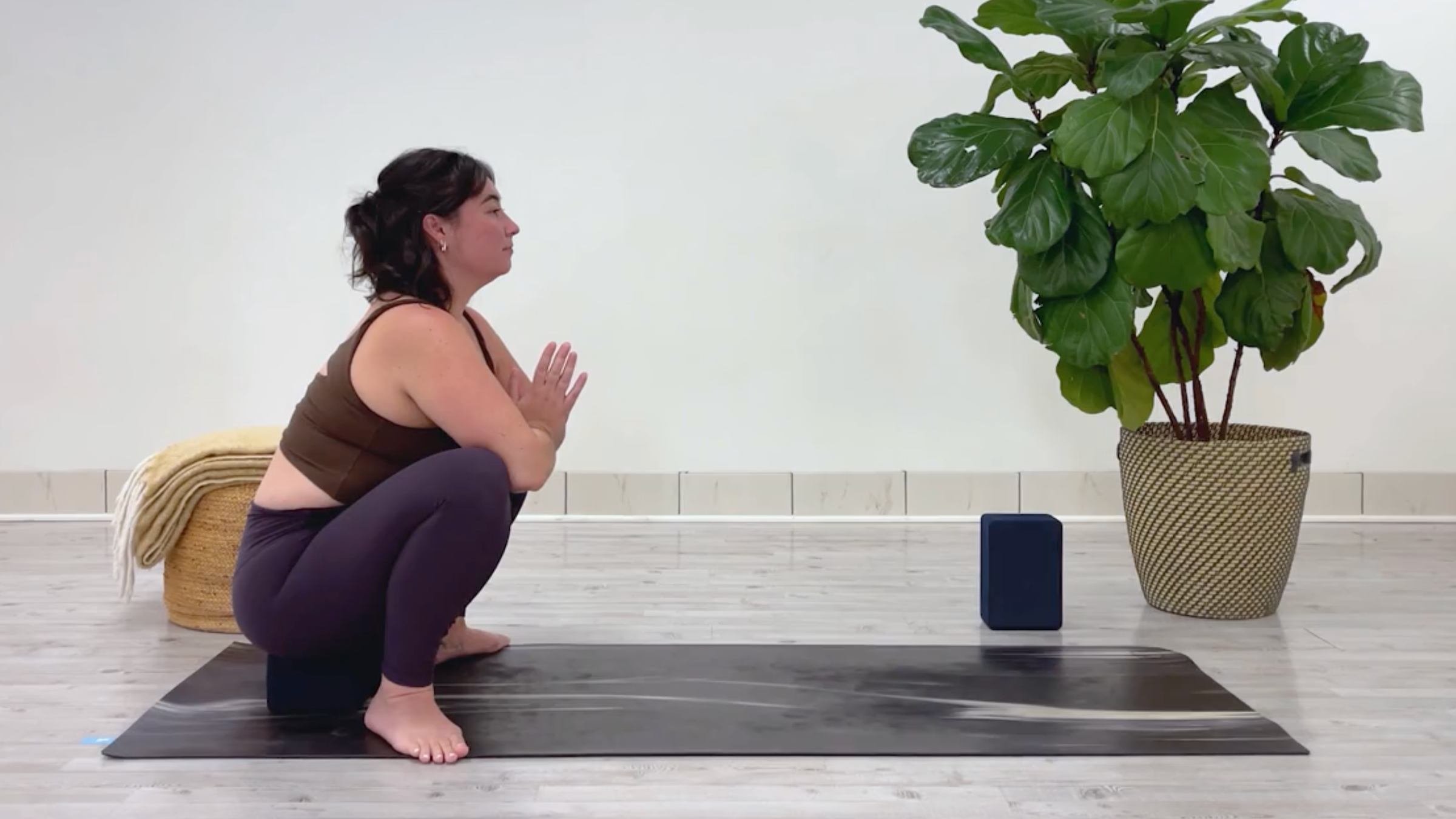 Yoga teacher Taylor Lorenz in Malasana, part of her 10-minute cool down yoga routine