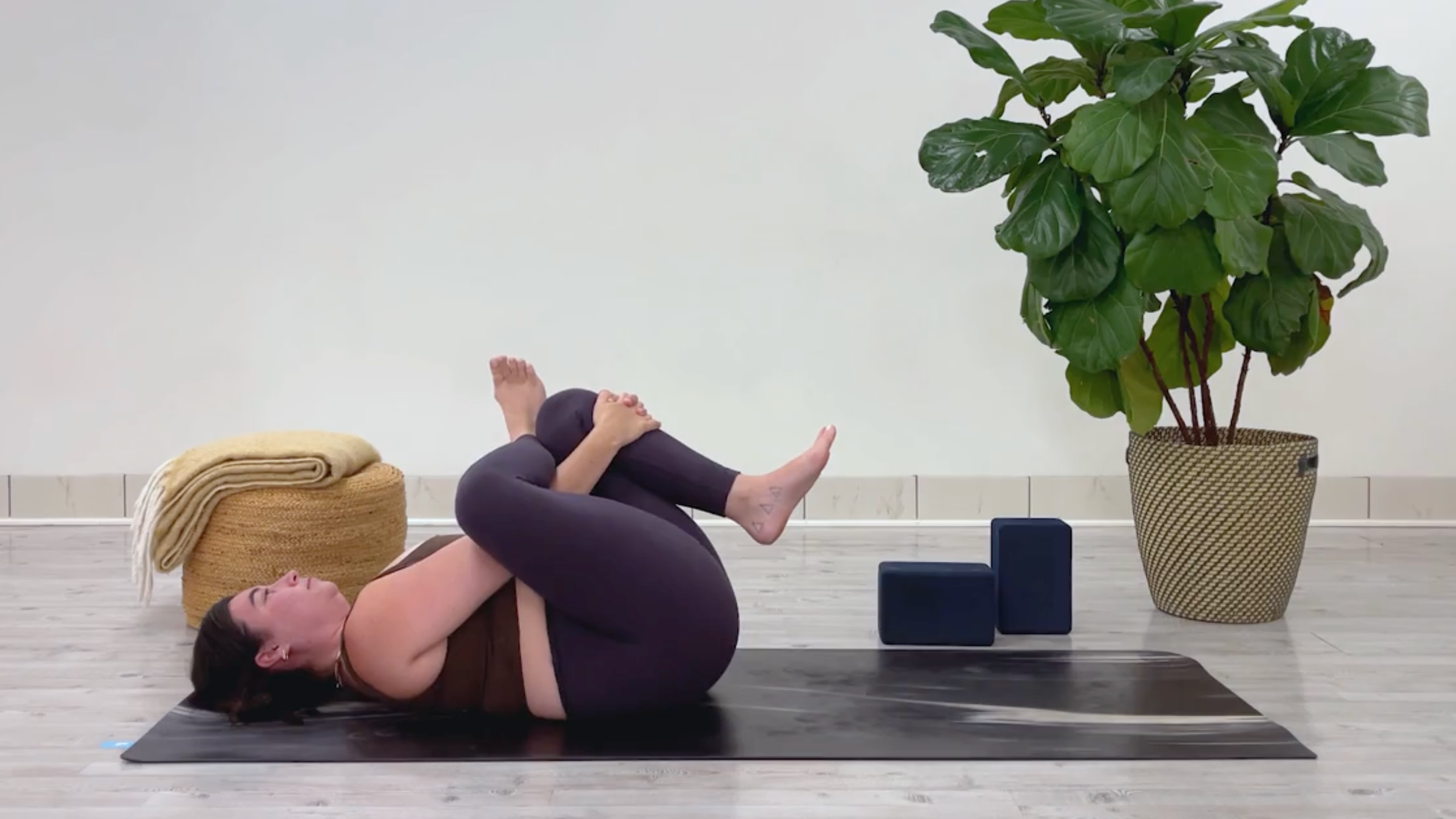 Yoga teacher Taylor Lorenz in Reclining Figure-4