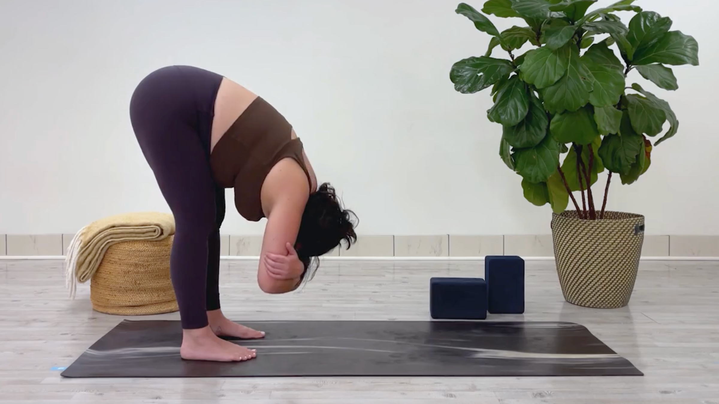 Yoga teacher Taylor Lorenz in Standing Forward Bend