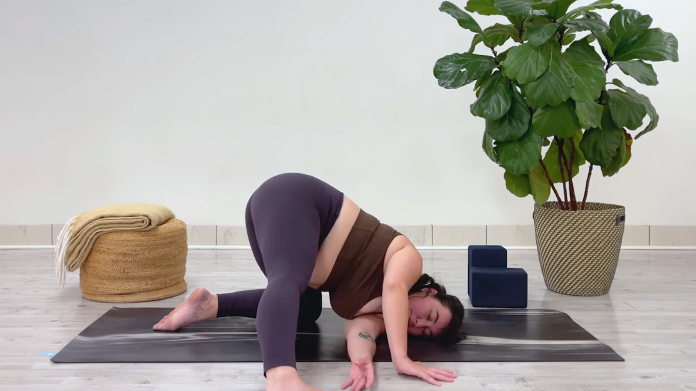 Yoga teacher Taylor Lorenz in Thread the Needle, part of her 10-minute cool down yoga routine