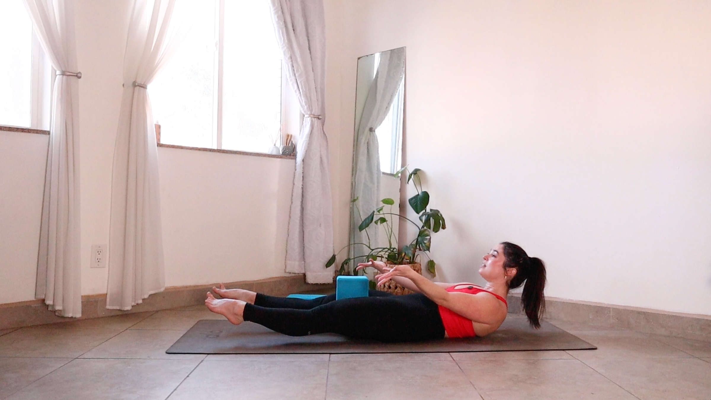 Yoga teacher Daria LeGrand in Low Boat Pose, one of her core strength exercises