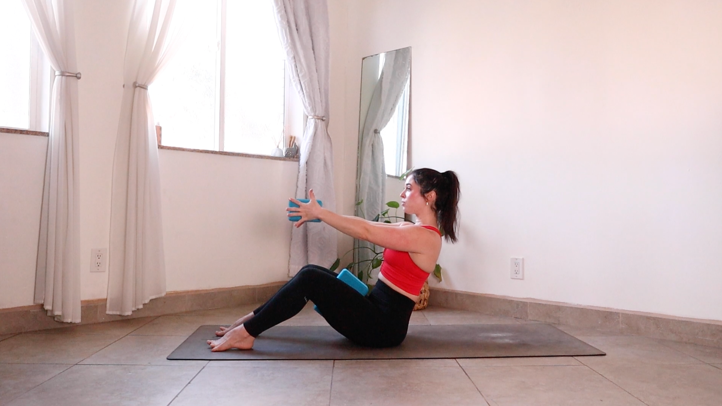 Yoga teacher Daria LeGrand practicing Roll Down, one of her core strength exercises