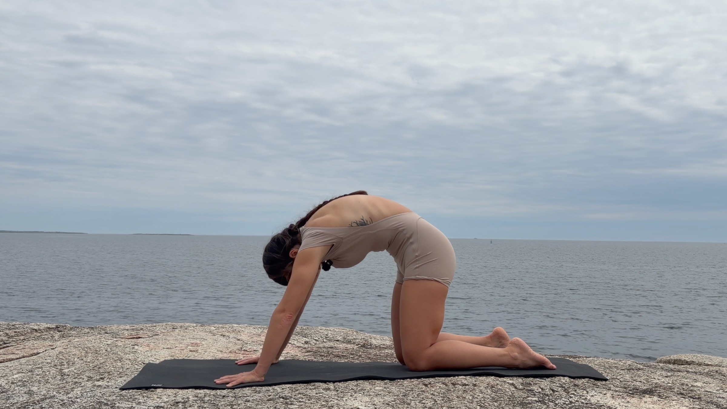 Teacher Emily Baltzer in Cat Pose, part of her daily yoga stretching routine