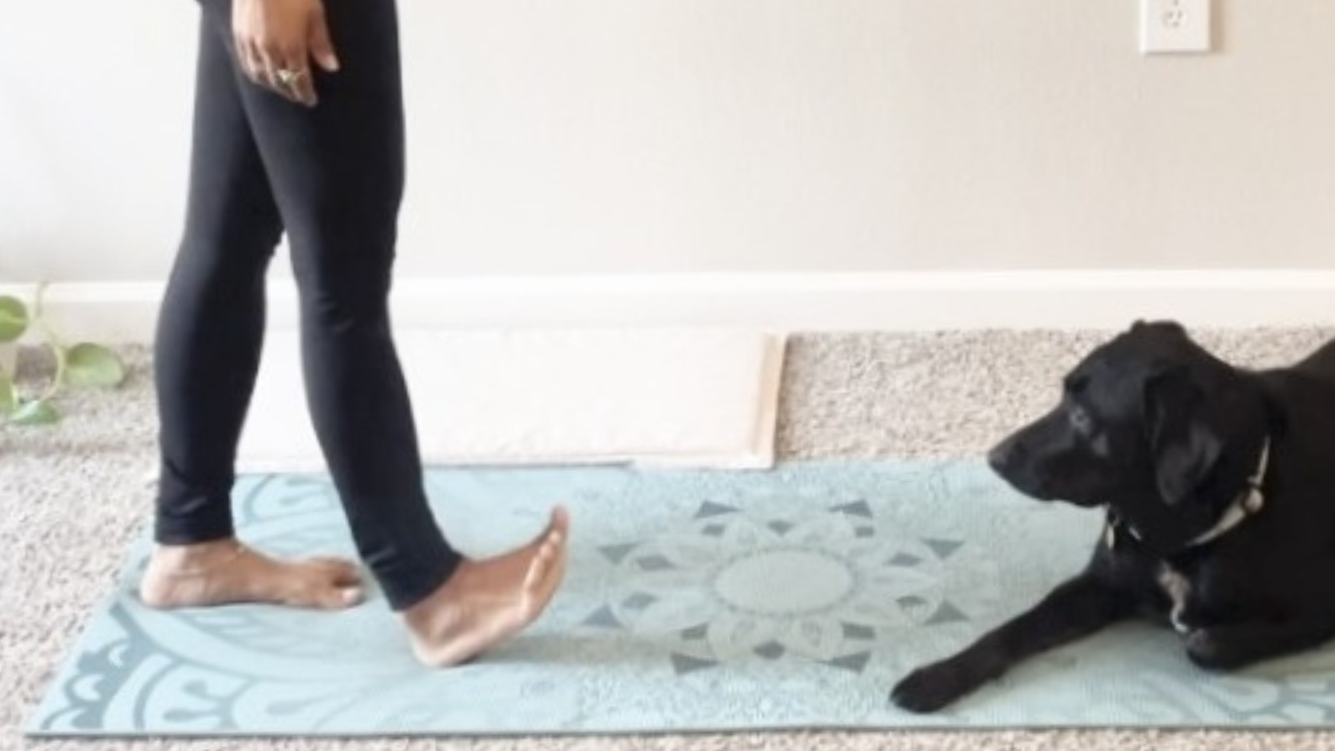 Woman stepping forward with her right foot on a yoga mat