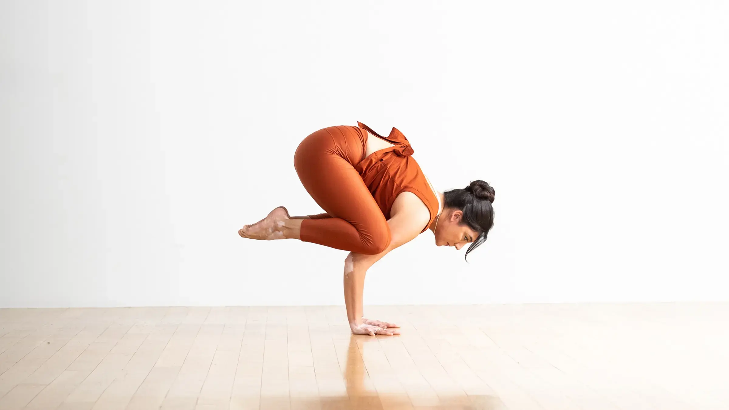 Woman in crow pose