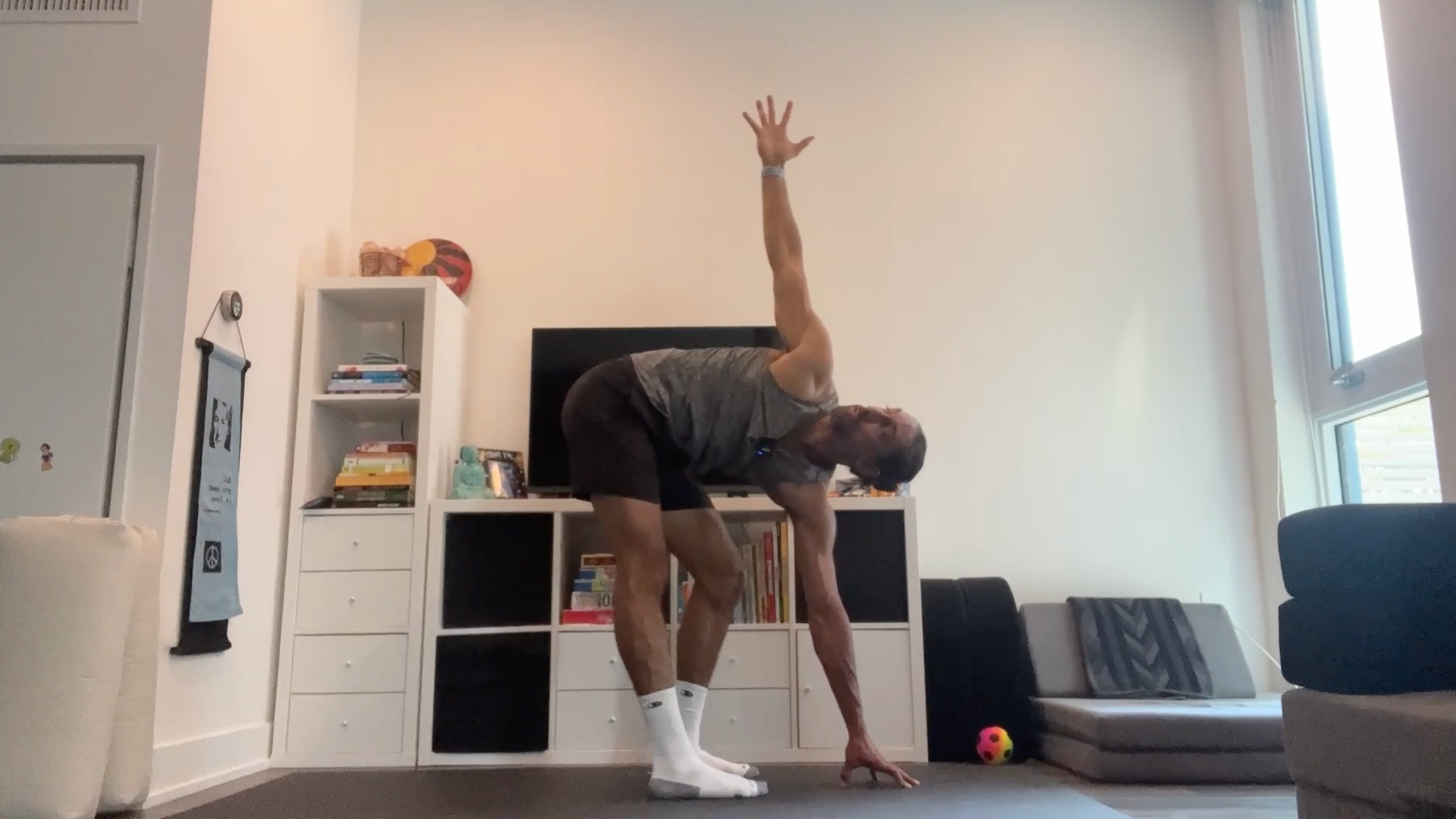 Yoga teacher Jaffer Hussain in Revolved Standing Forward Bend