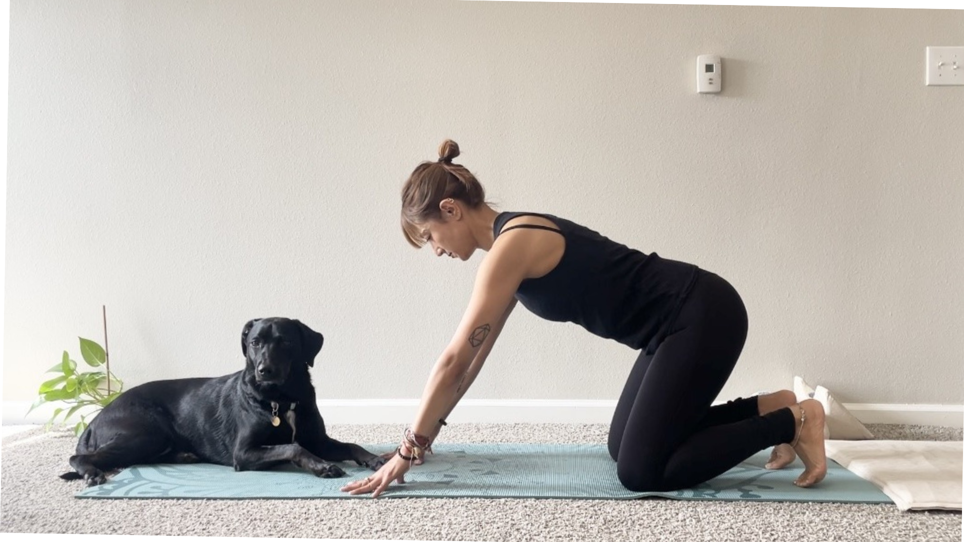 Woman kneeling and balancing on her knees and her fingertips