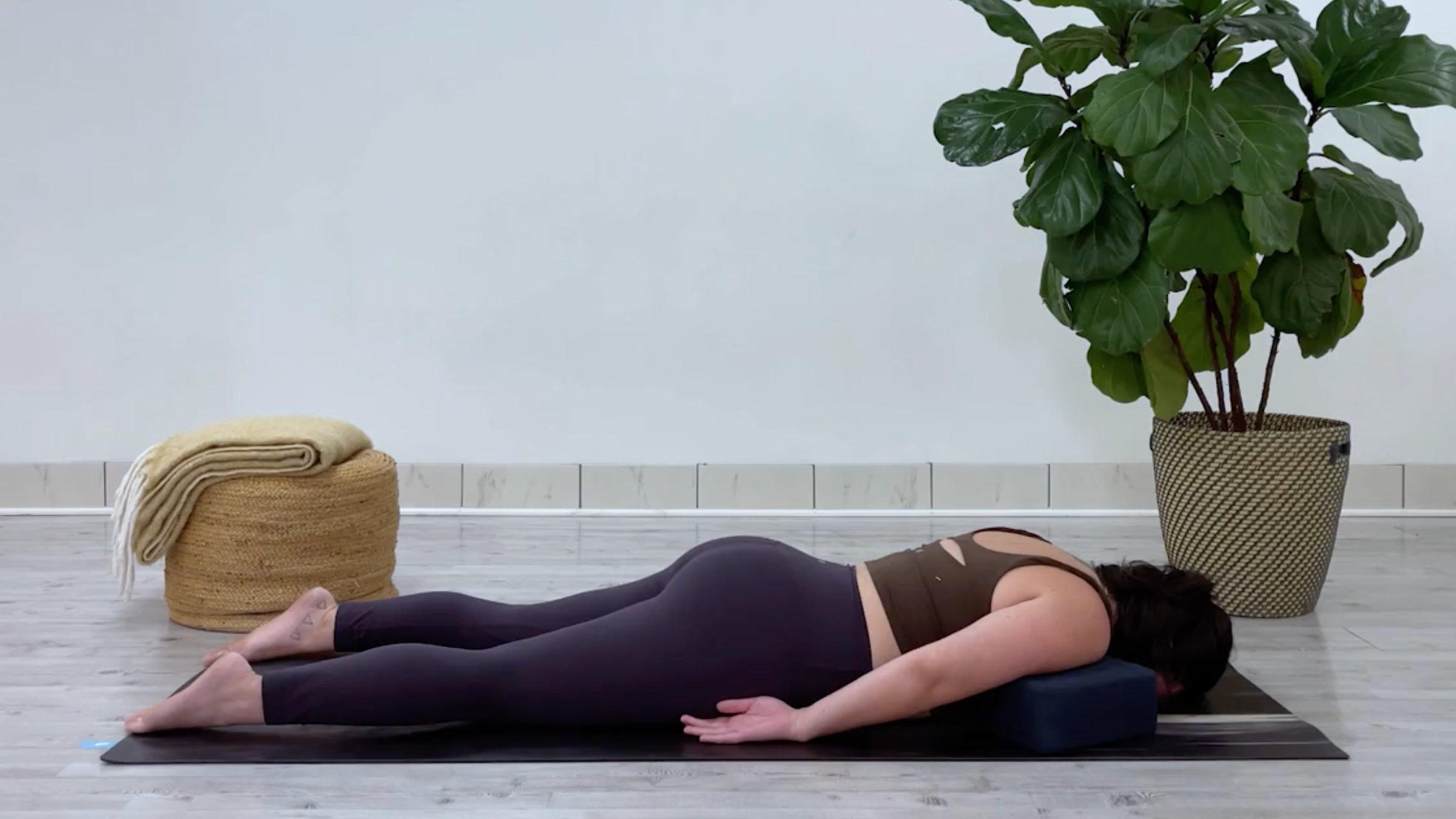 Yoga teacher Taylor Lorenz in Supported Sphinx, part of her yin yoga for stress routine