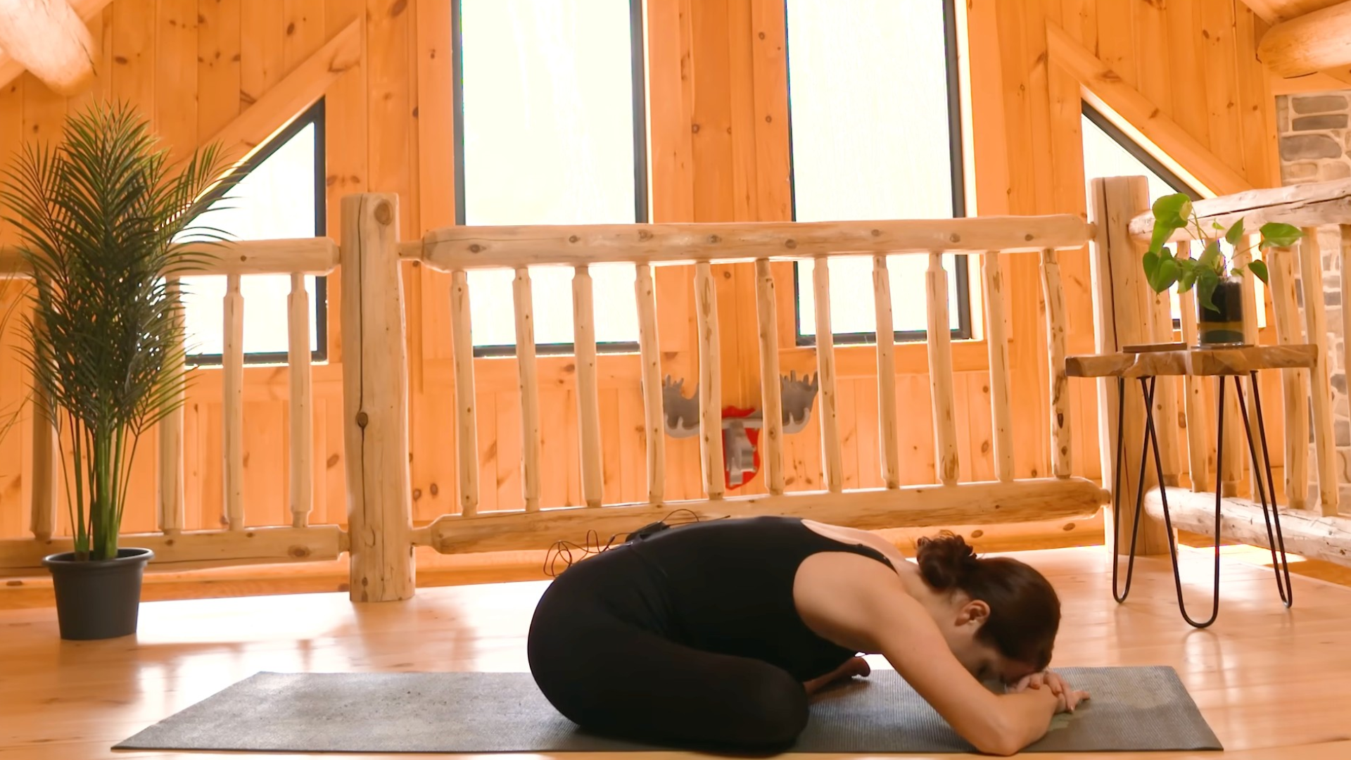 Woman sitting and leaning forward in a yoga class
