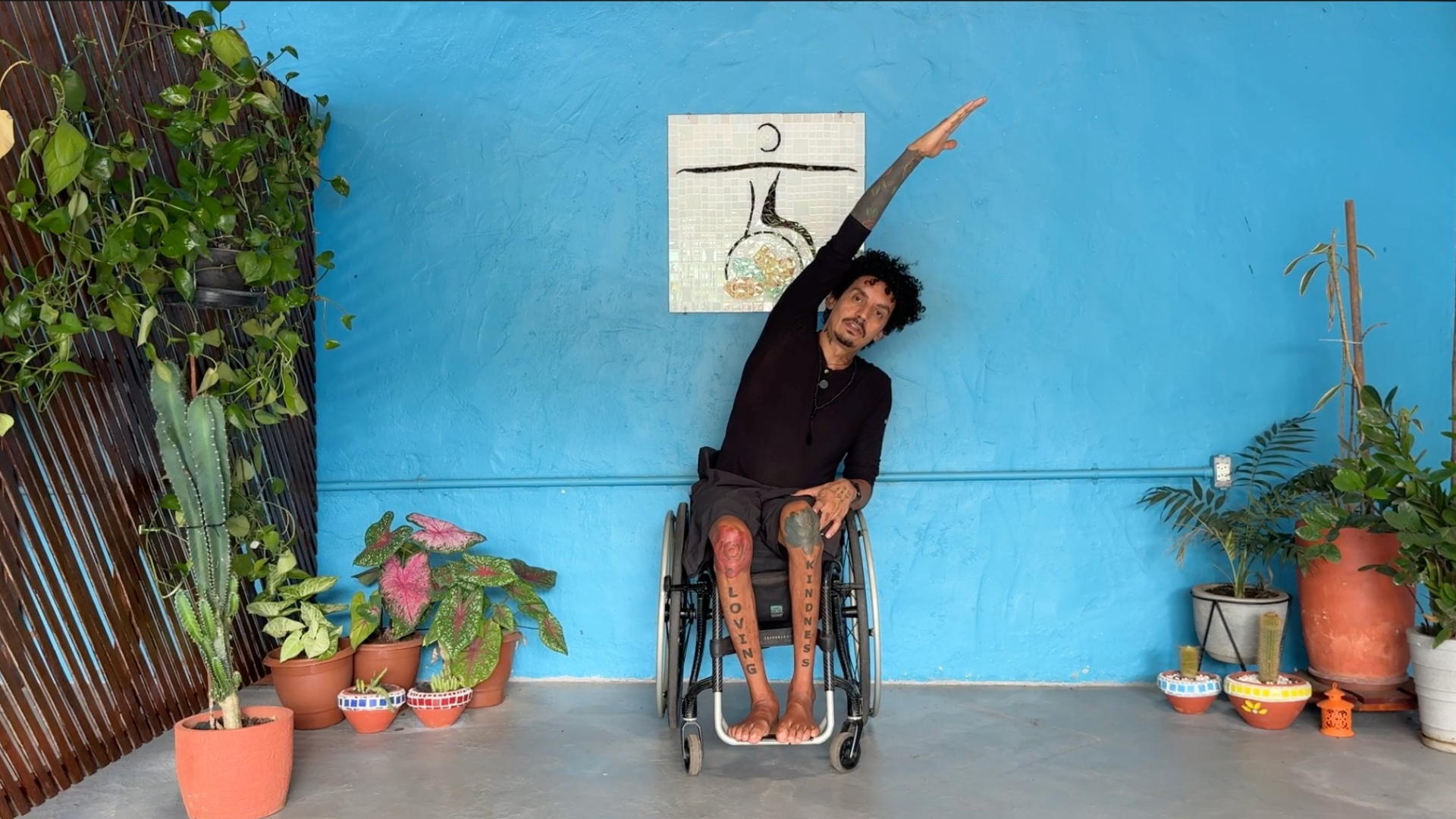 Man seated in a wheelchair leaning toward the right