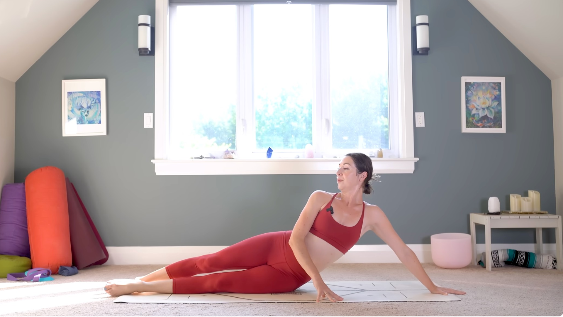 Woman leaning on her side with her bottom palm on the mat.