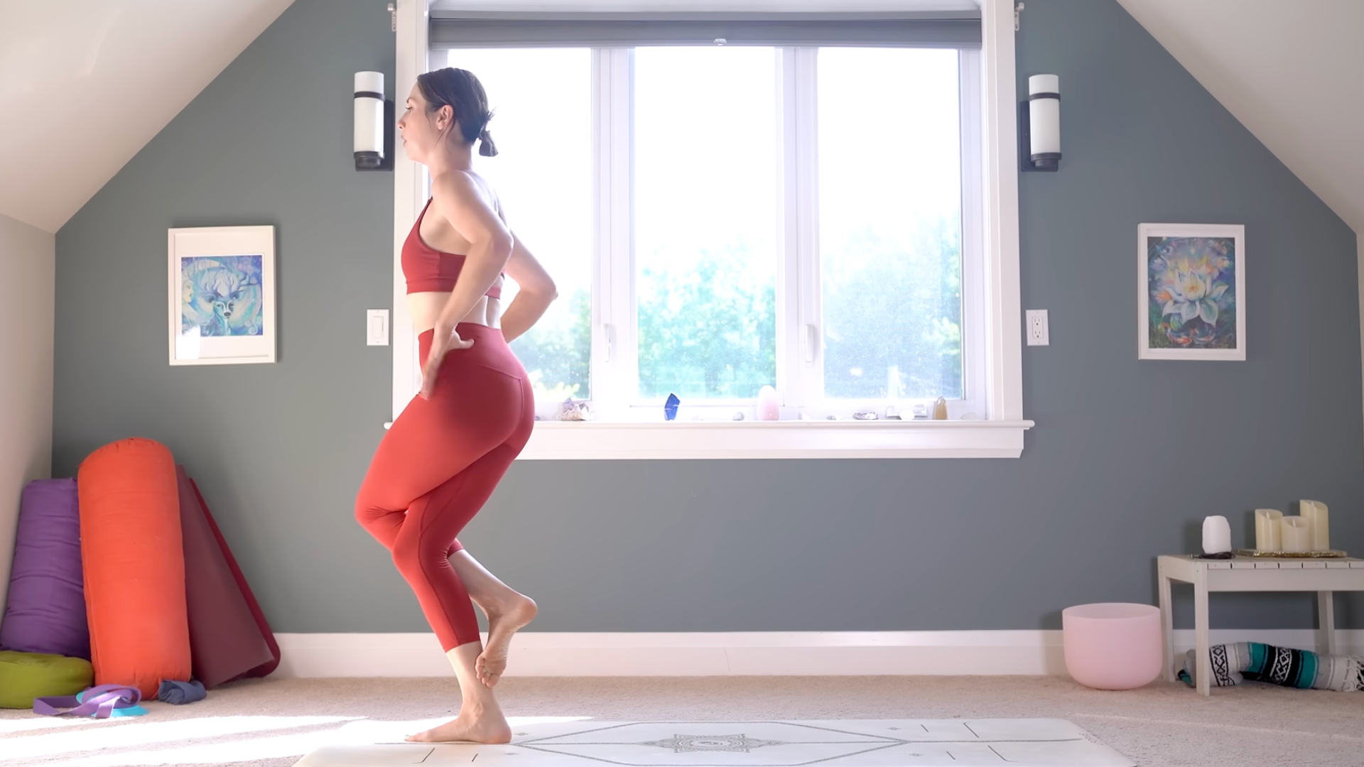 Woman standing with Eagle or Garudasana legs, one thigh crossed over the other