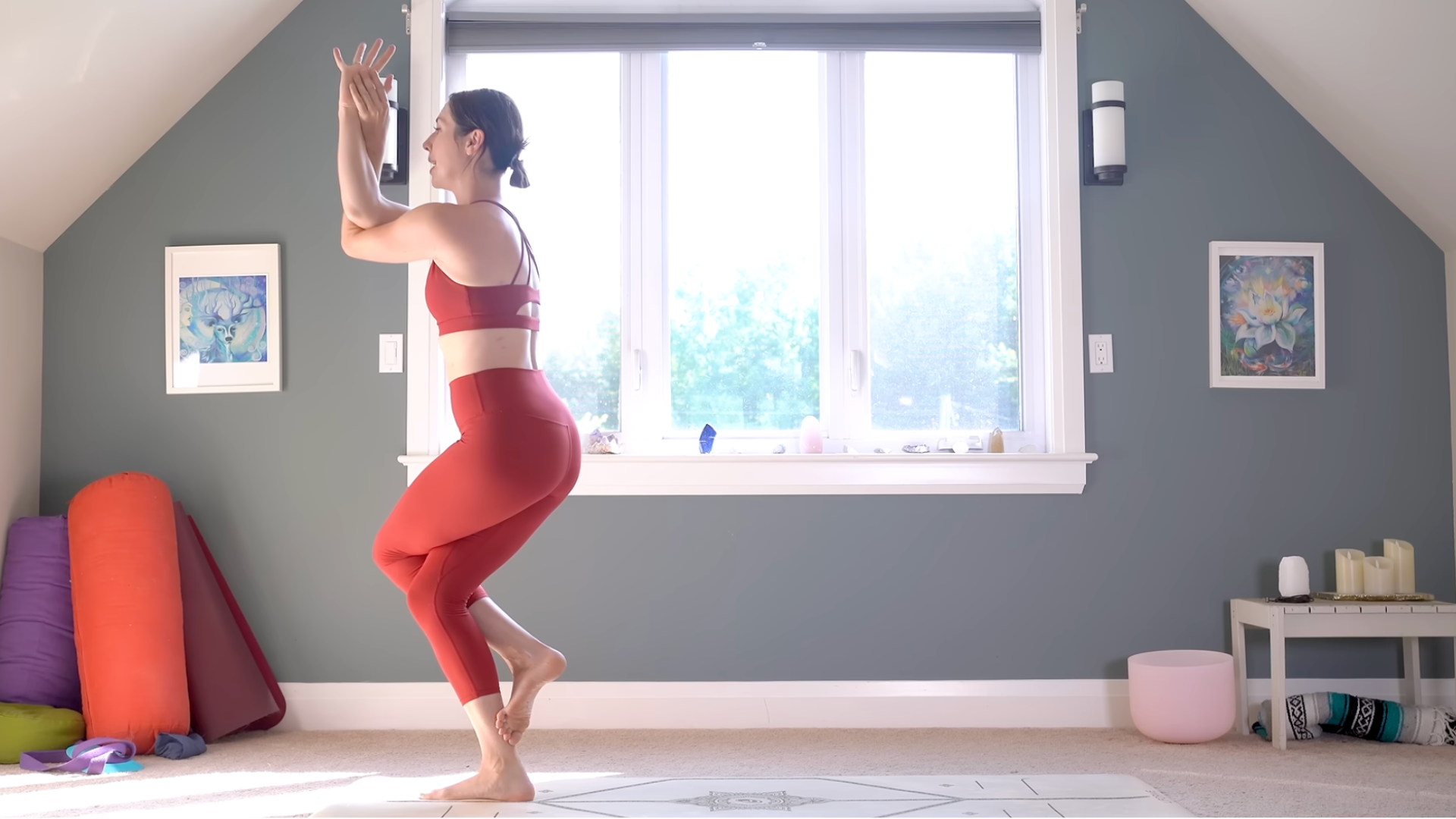 Woman in Eagle or Garudasana with her elbows and her thighs crossed