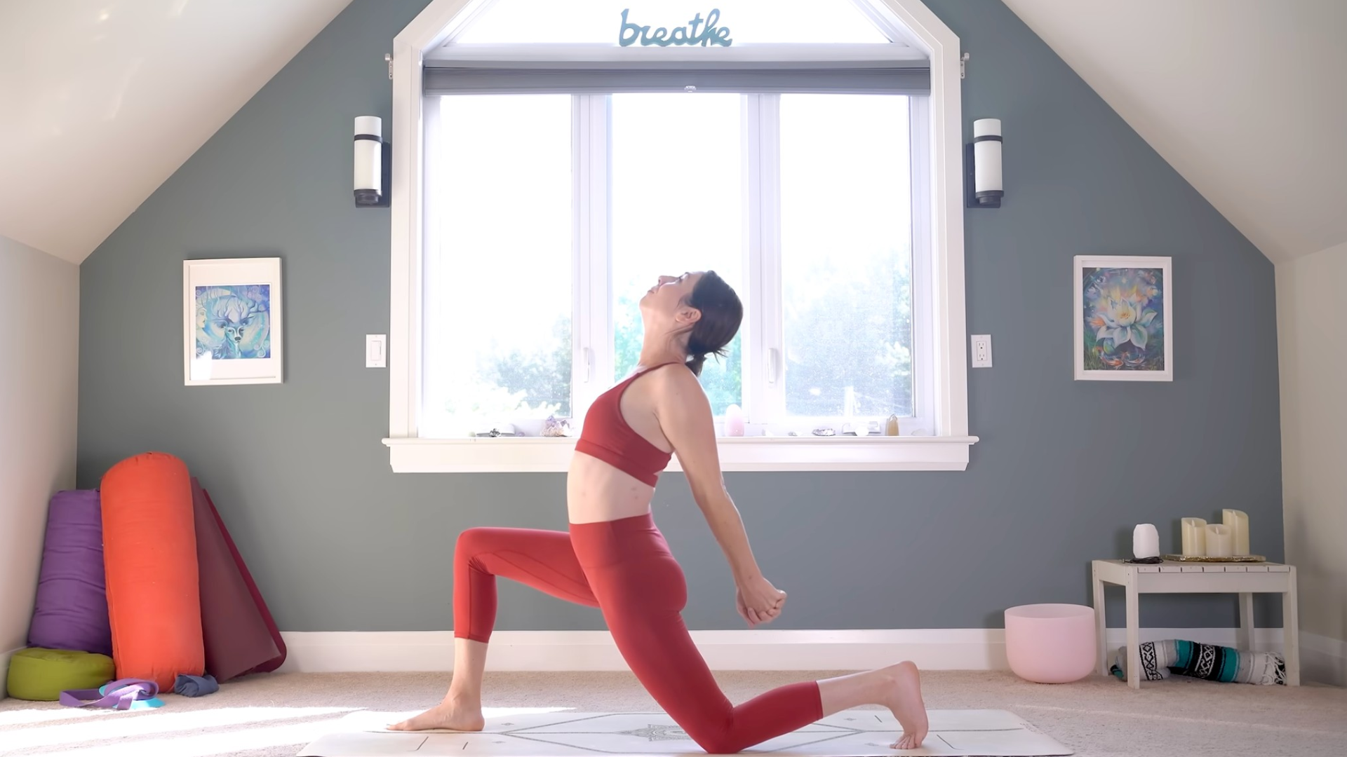 Woman kneeling on a yoga mat in Low Lunge