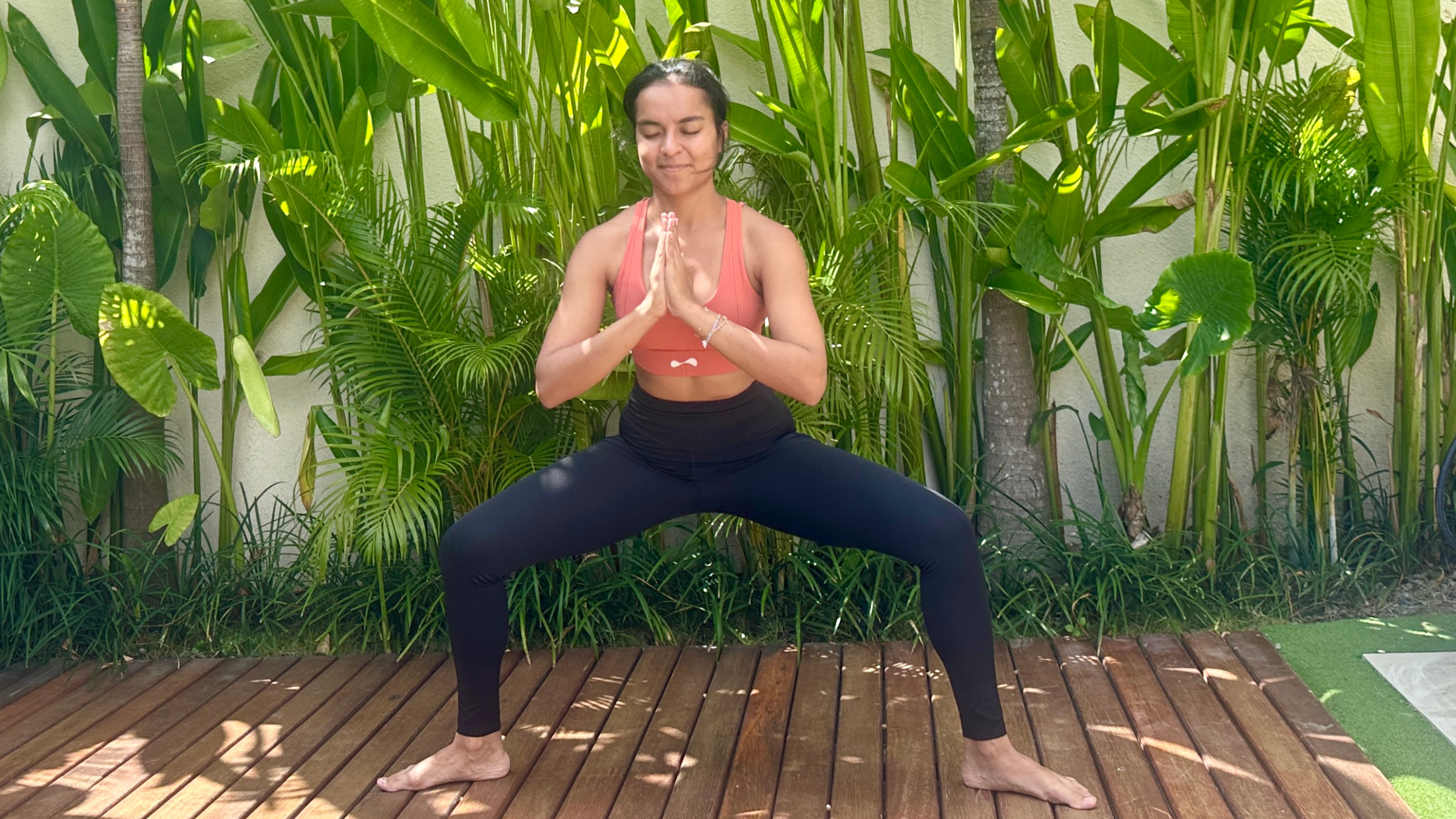 Yoga teacher practicing Goddess Pose.