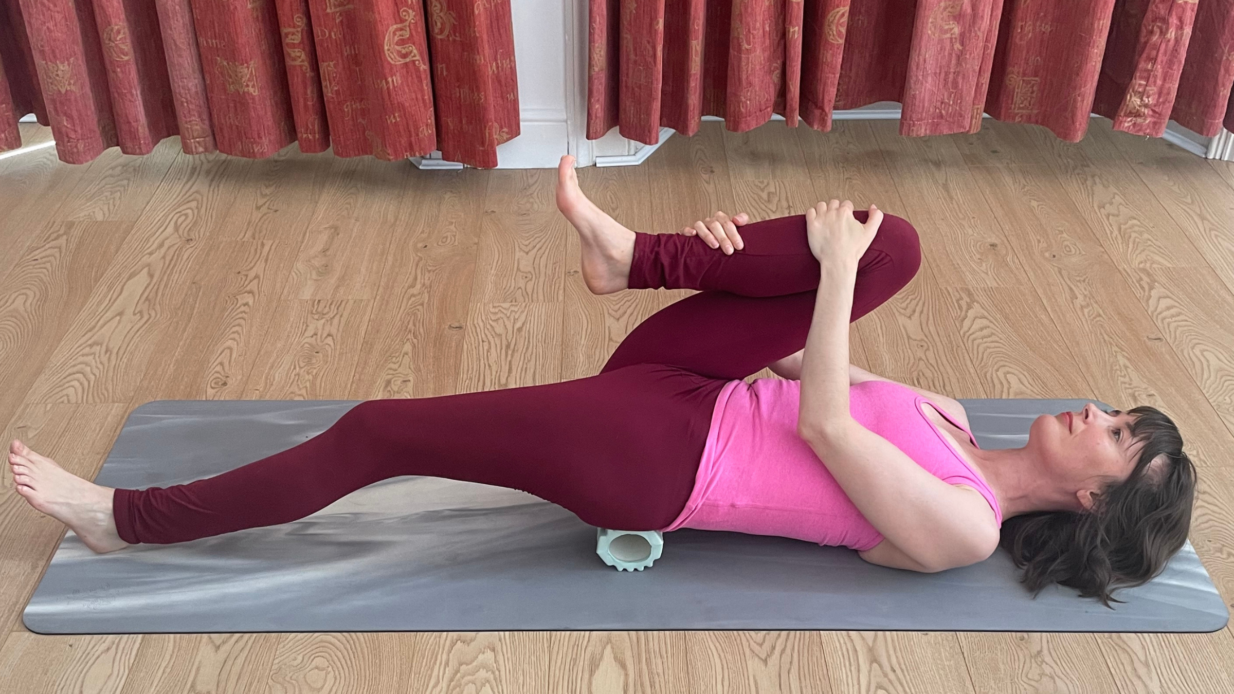 Amber Burke practicing Half Wind Relieving Pose.