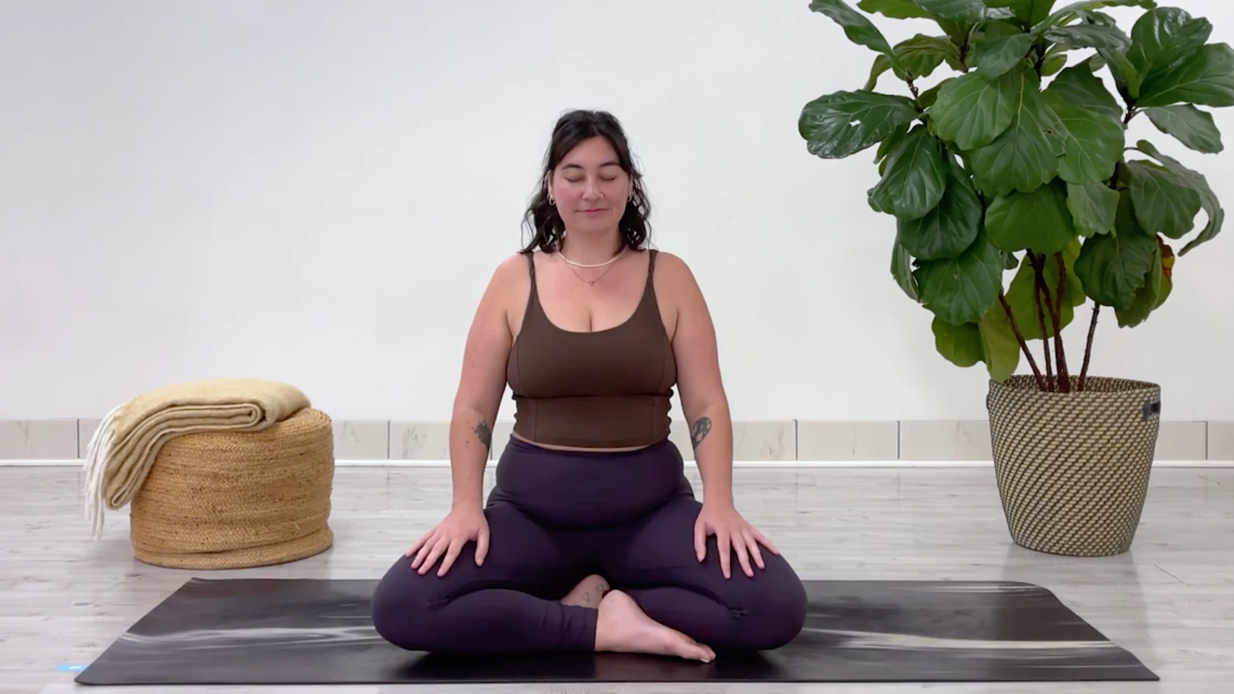 Yoga teacher Taylor Lorenz setting up for a breathing exercise