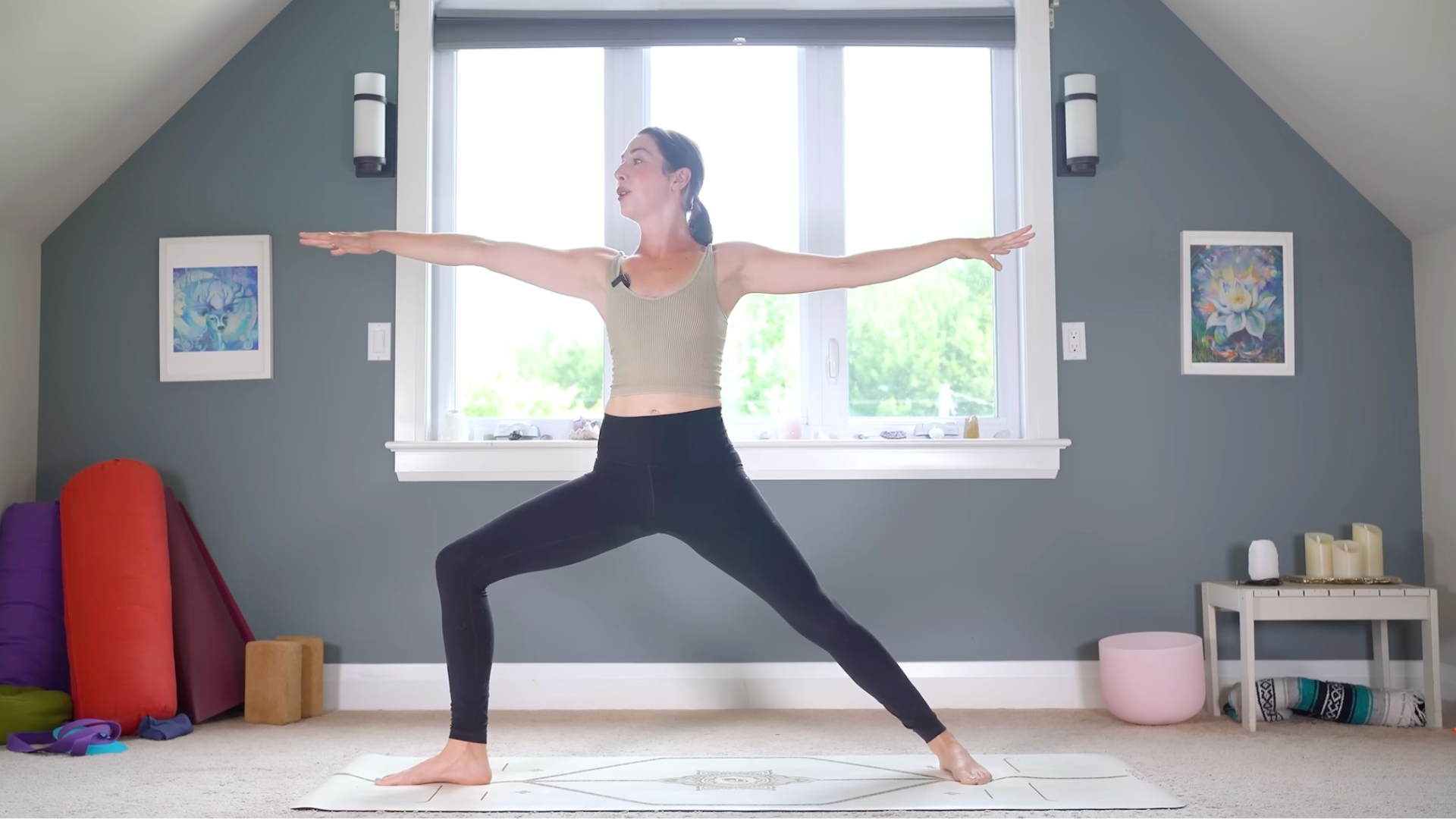Woman practicing a full-body stretch yoga routine while in Warrior 2 or Virabhadrasana II