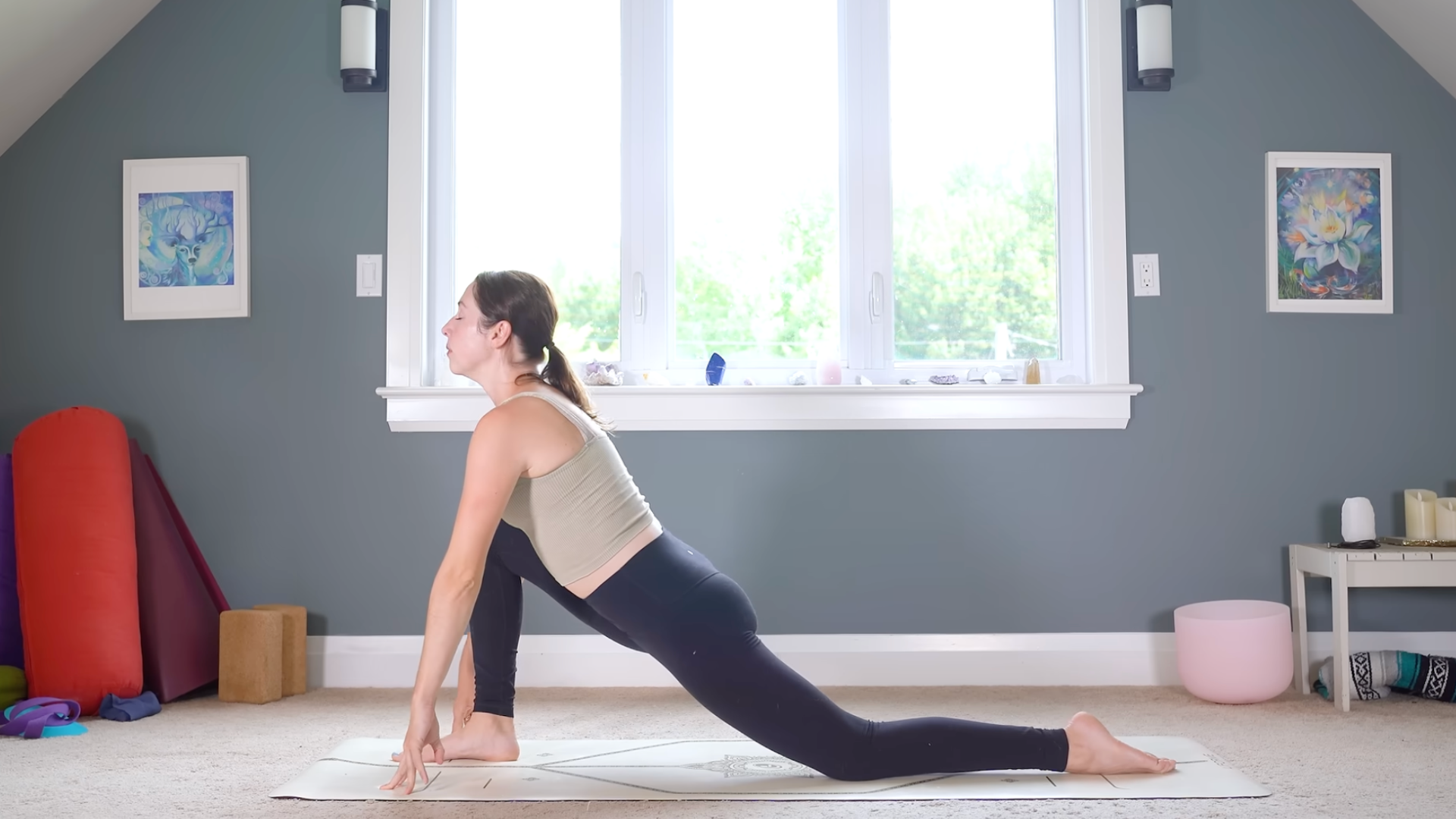 Woman in Low Lunge on a yoga mat during a full-body stretch
