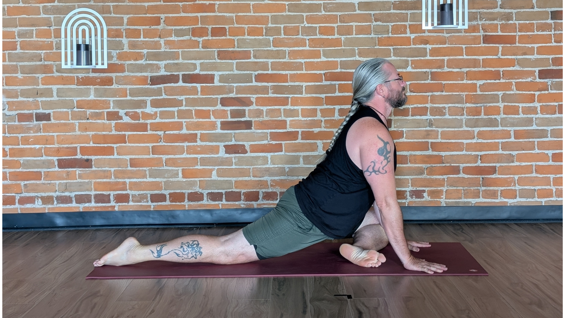 Yoga teacher in pigeon pose or eka pada rajakapotasana