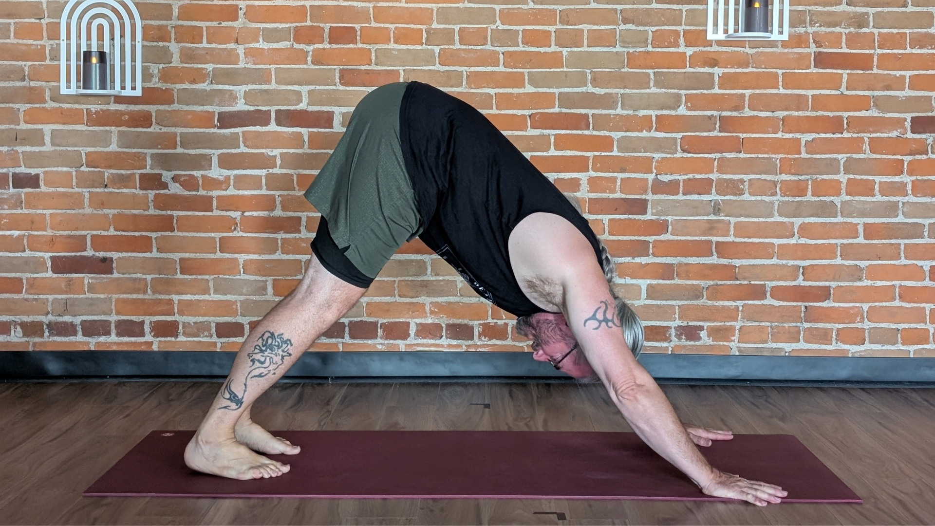 Man in Downward-Facing Dog on a yoga mat