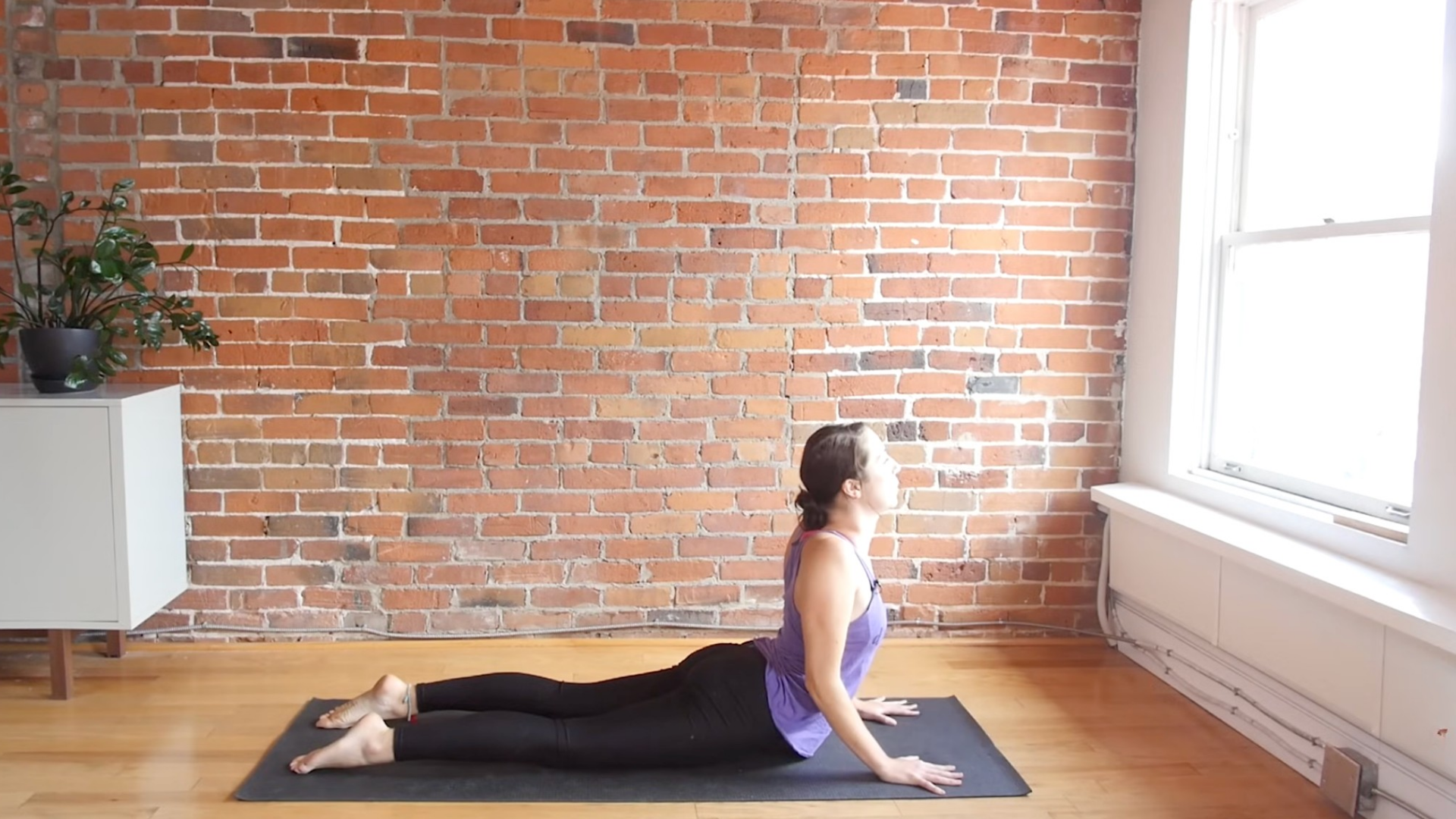 Woman lying on her belly in Cobra pose