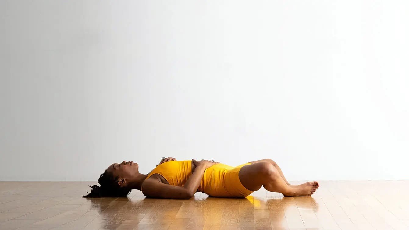 A person in Reclining Bound Angle, a yoga for sleep pose