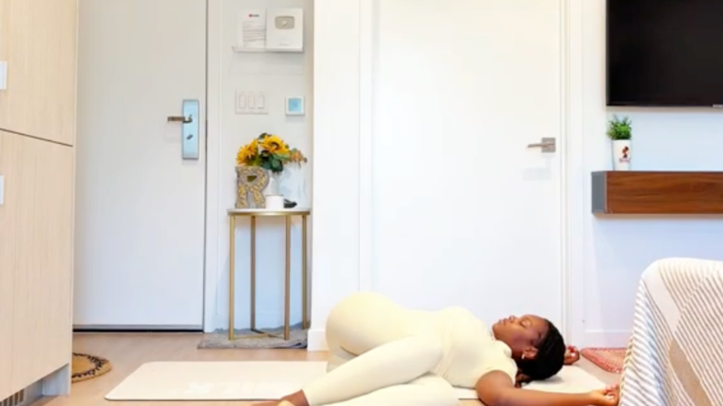 Yoga instructor Ramoni Overton does a supine spinal twist.