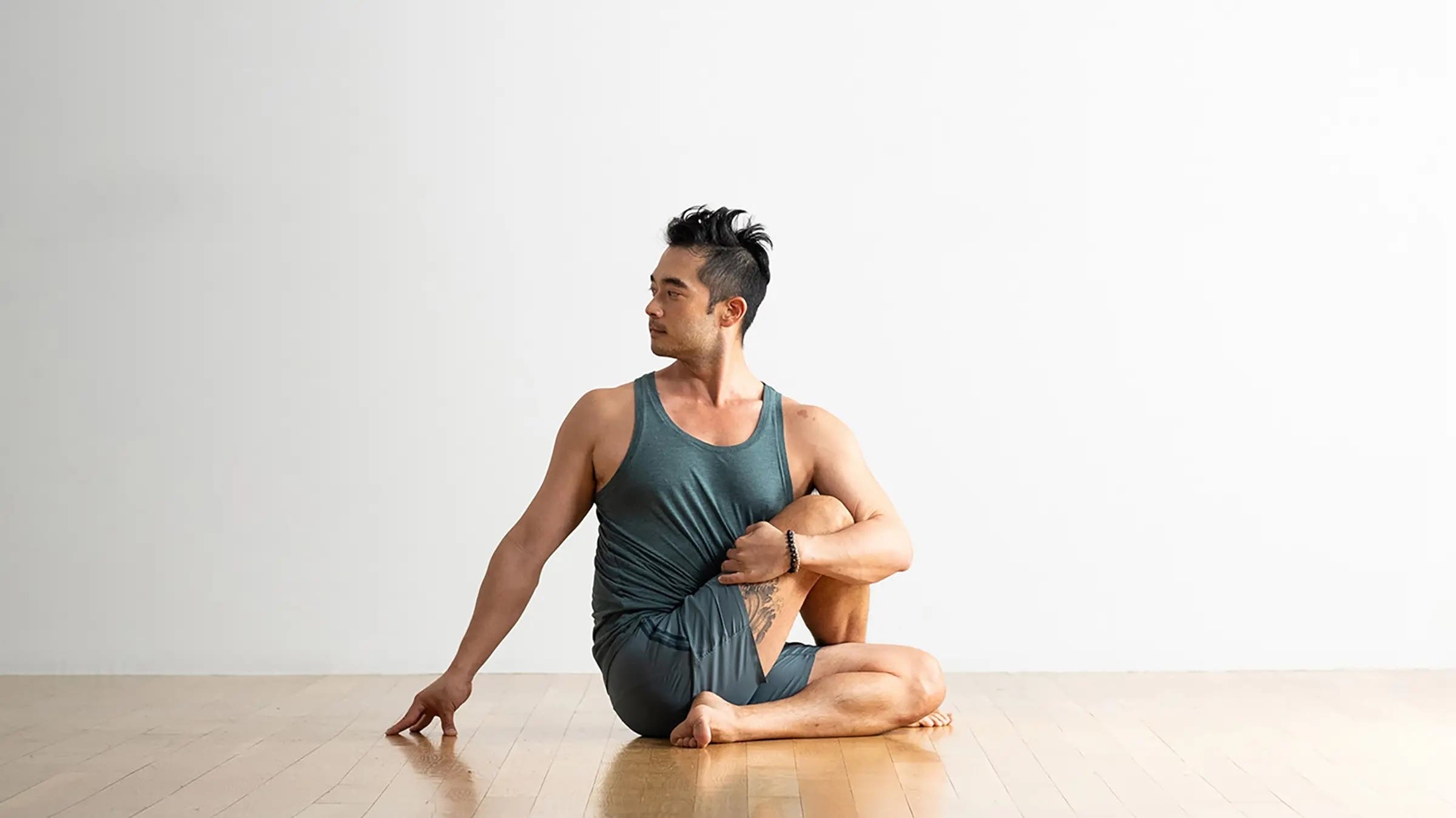 A man in Half Lord of the Fishes, or Ardha Matsyendrasana in Sanskrit