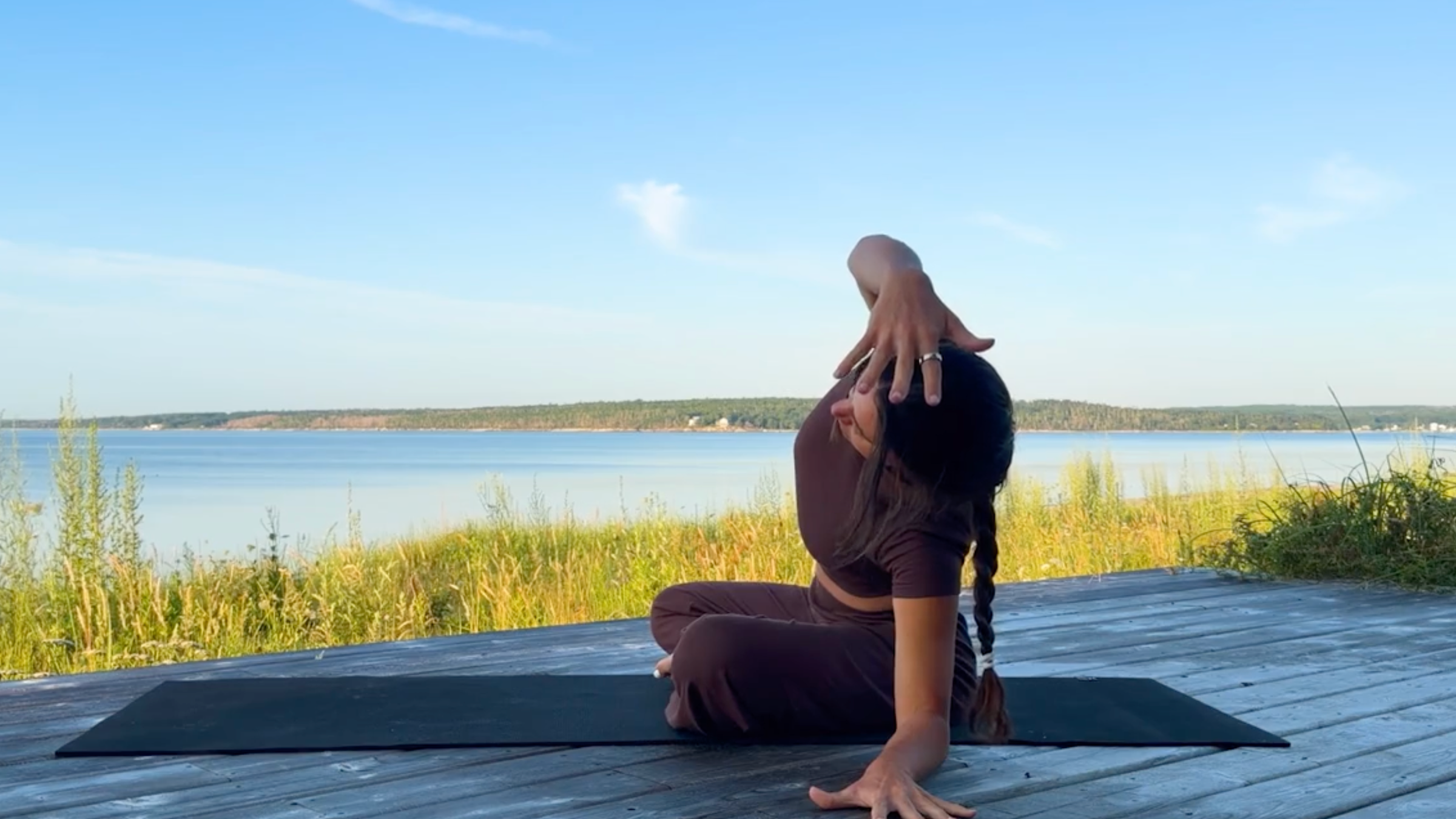 Yoga teacher Emily Baltzer in Seated Side Stretch, one of her seated yoga poses