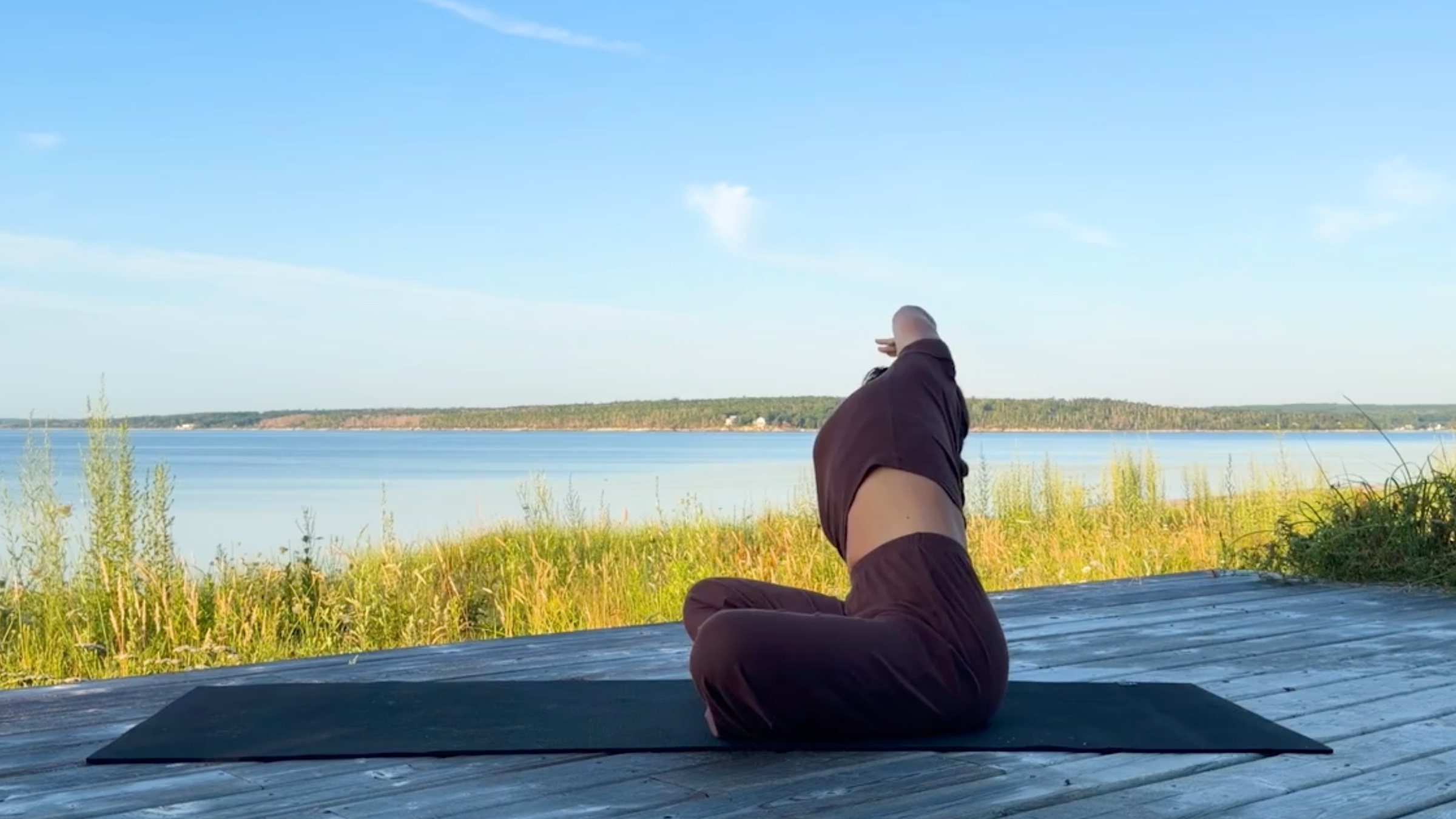 Yoga teacher Emily Baltzer in Seated Side Stretch, one of her seated yoga poses