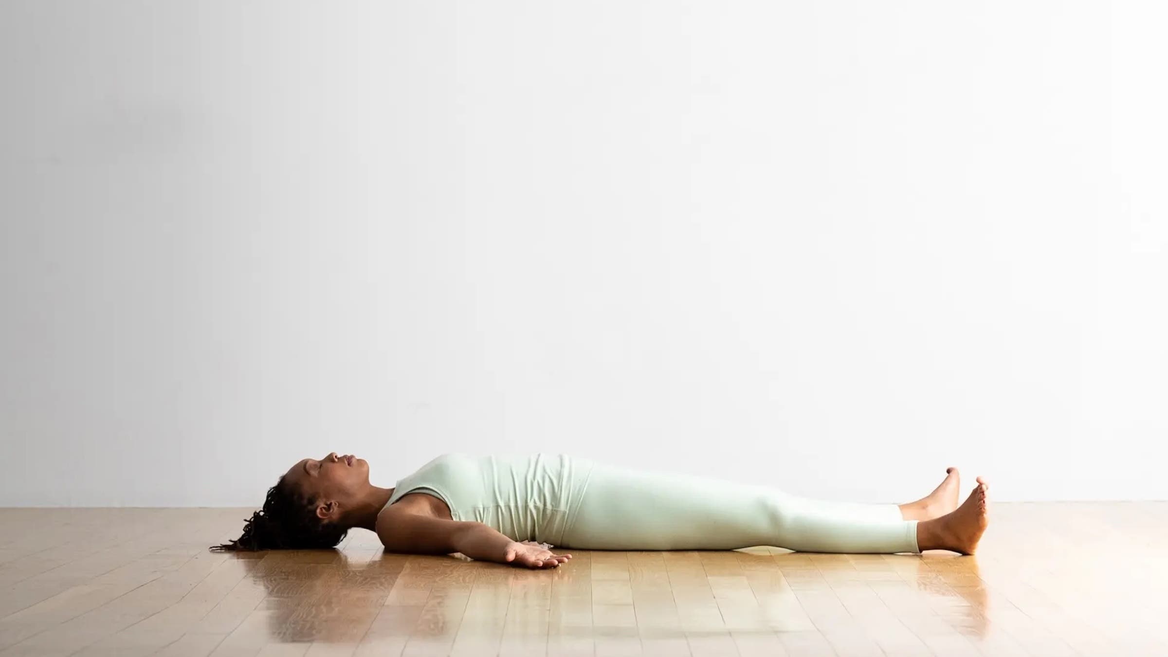 A yoga teacher in Corpse Pose, Savasana in Sanskrit, one of the most whimsical yoga poses
