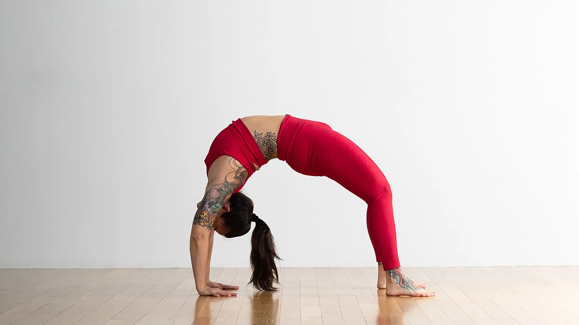 A yoga teacher in Wheel Pose, Urdhva Dhanurasana in Sanskrit