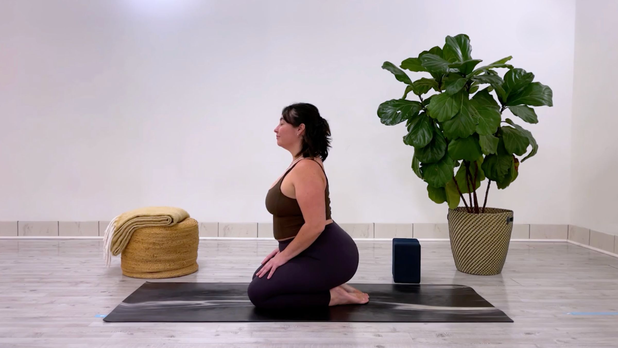 teacher Taylor Lorenz in Kneeling Cow Pose