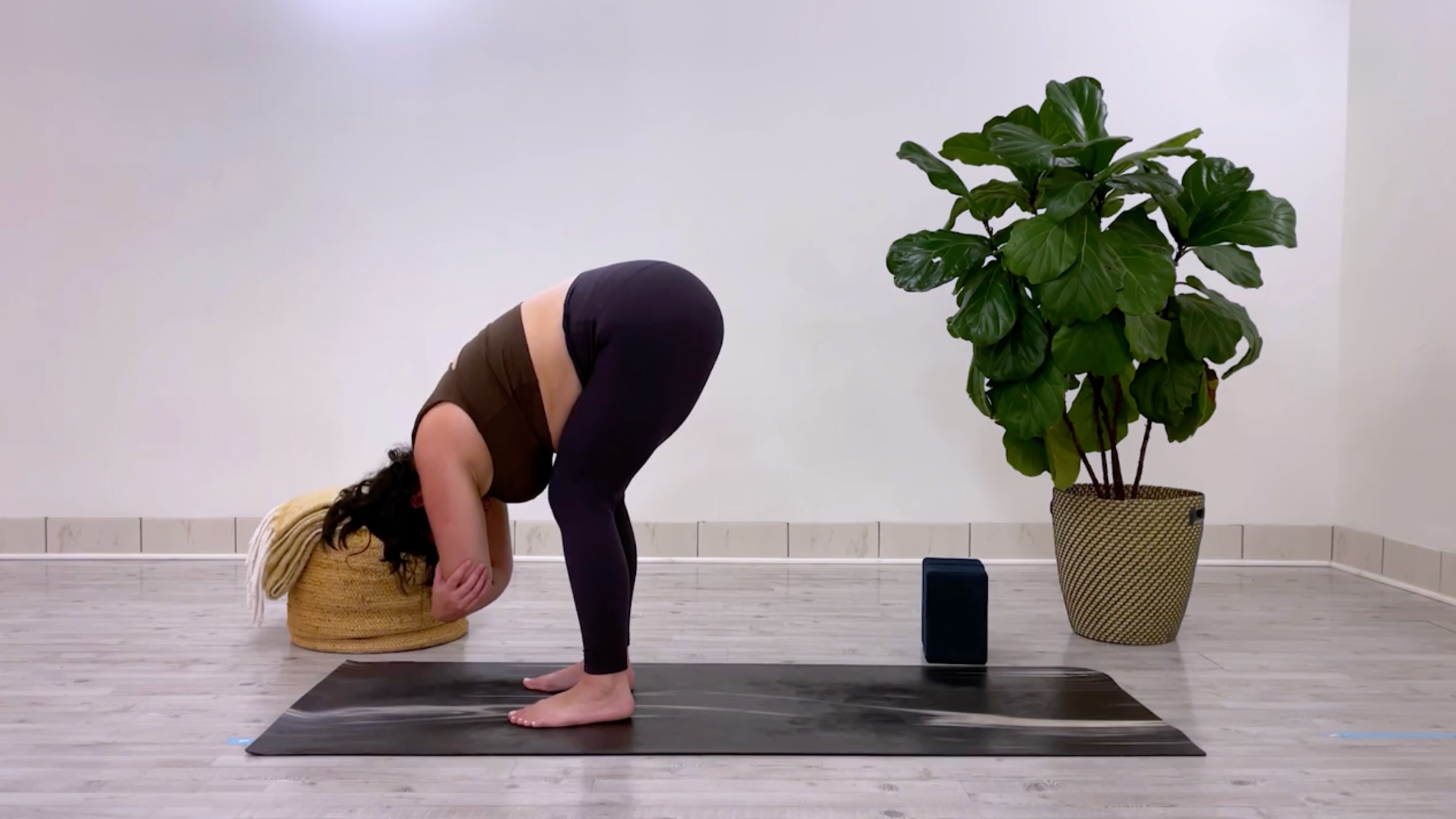 teacher Taylor Lorenz in Standing Forward Bend, or Uttanasana