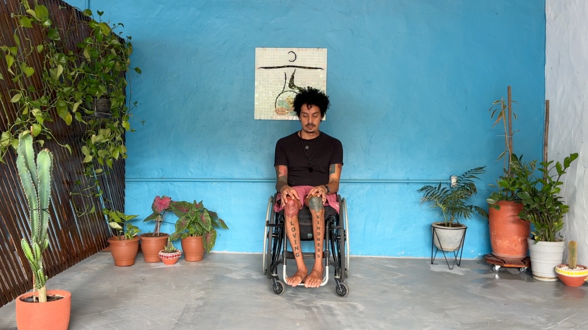 Rodrigo Souza leading a chair yoga class through neck stretches by tilting his chin toward his chest