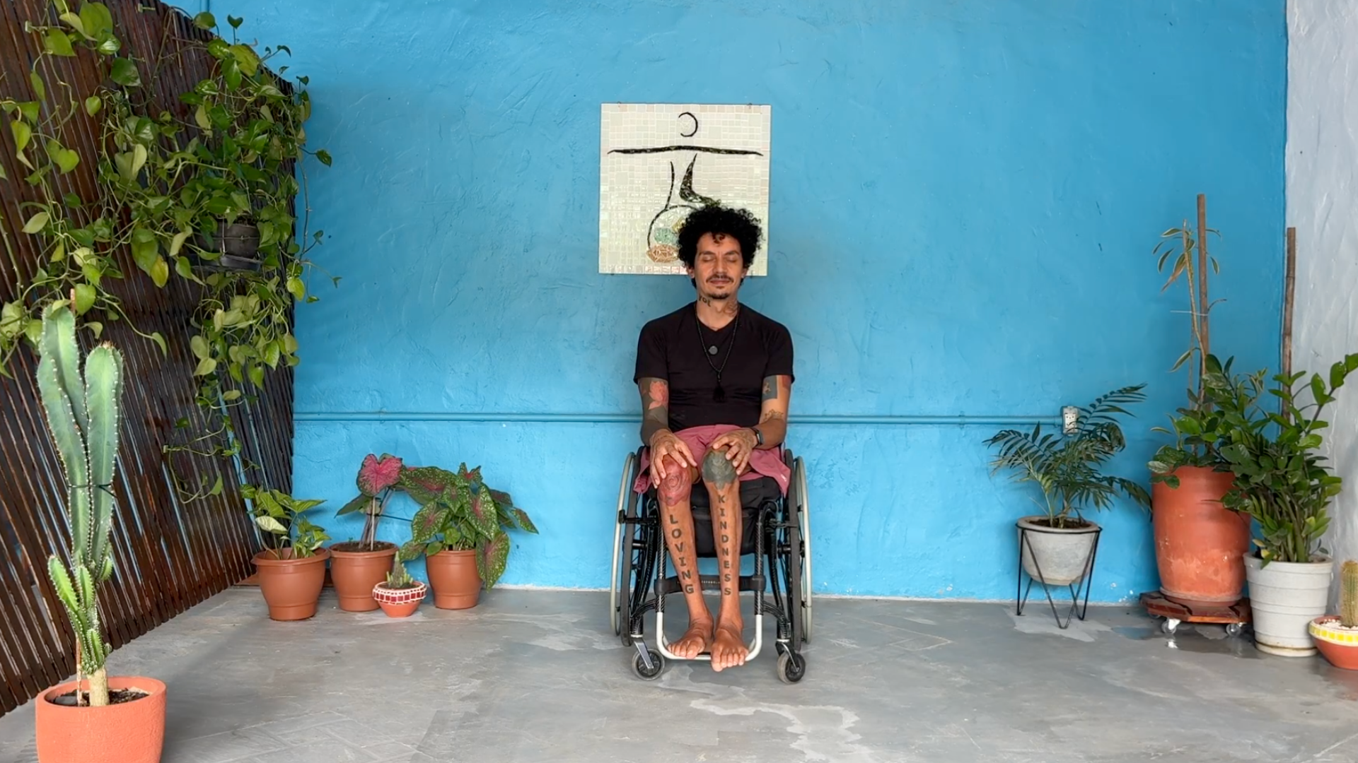 Adaptive and accessible yoga teacher Rodrigo Souza ends class with a moment of quiet introspection