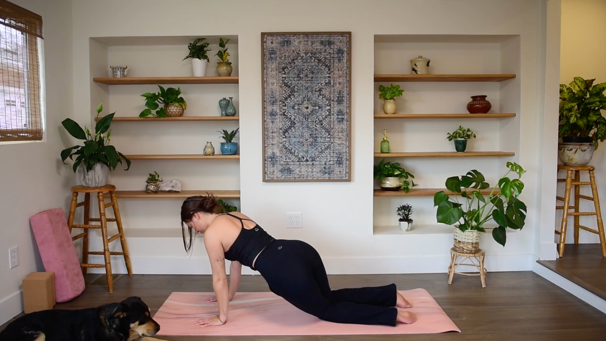 Caitlin K'eli on hands and knees gently lowering her hips toward the side of the mat in a Gentle Hip Twist.