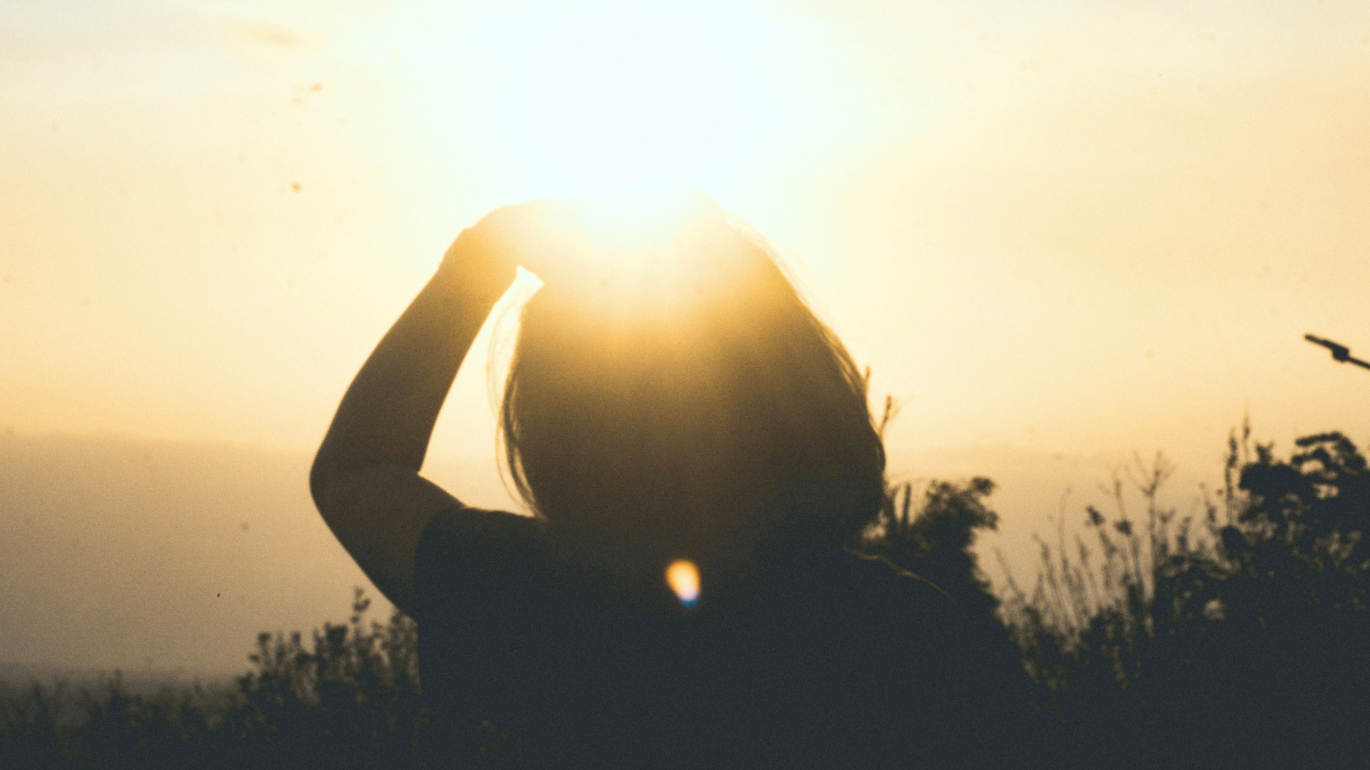 Woman standing outside in the early morning light of the Sun while thinking about her weekly horoscope for October 11-17