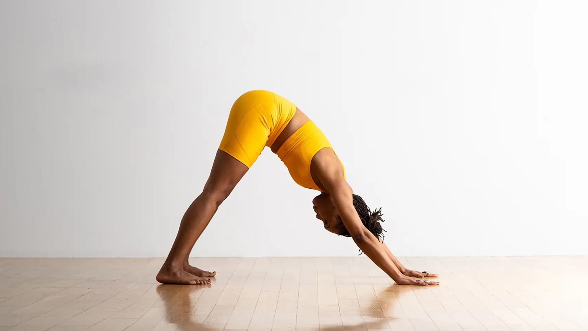 A woman in Downward-Facing Dog, Adho Mukha Svanasana in Sanskrit