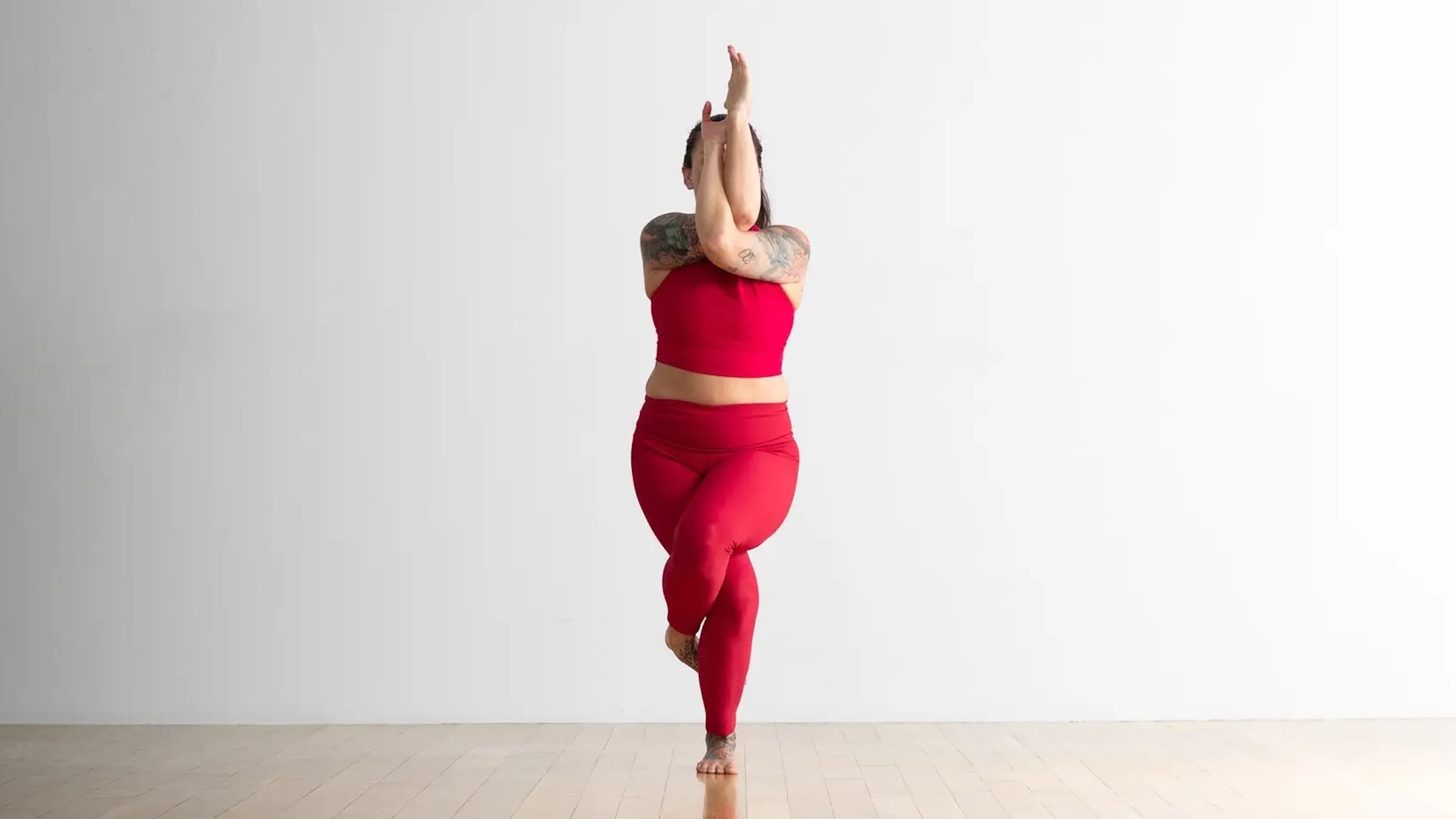 A woman in Eagle Pose, Garudasana in Sanskrit, one of our favorite wrist stretches
