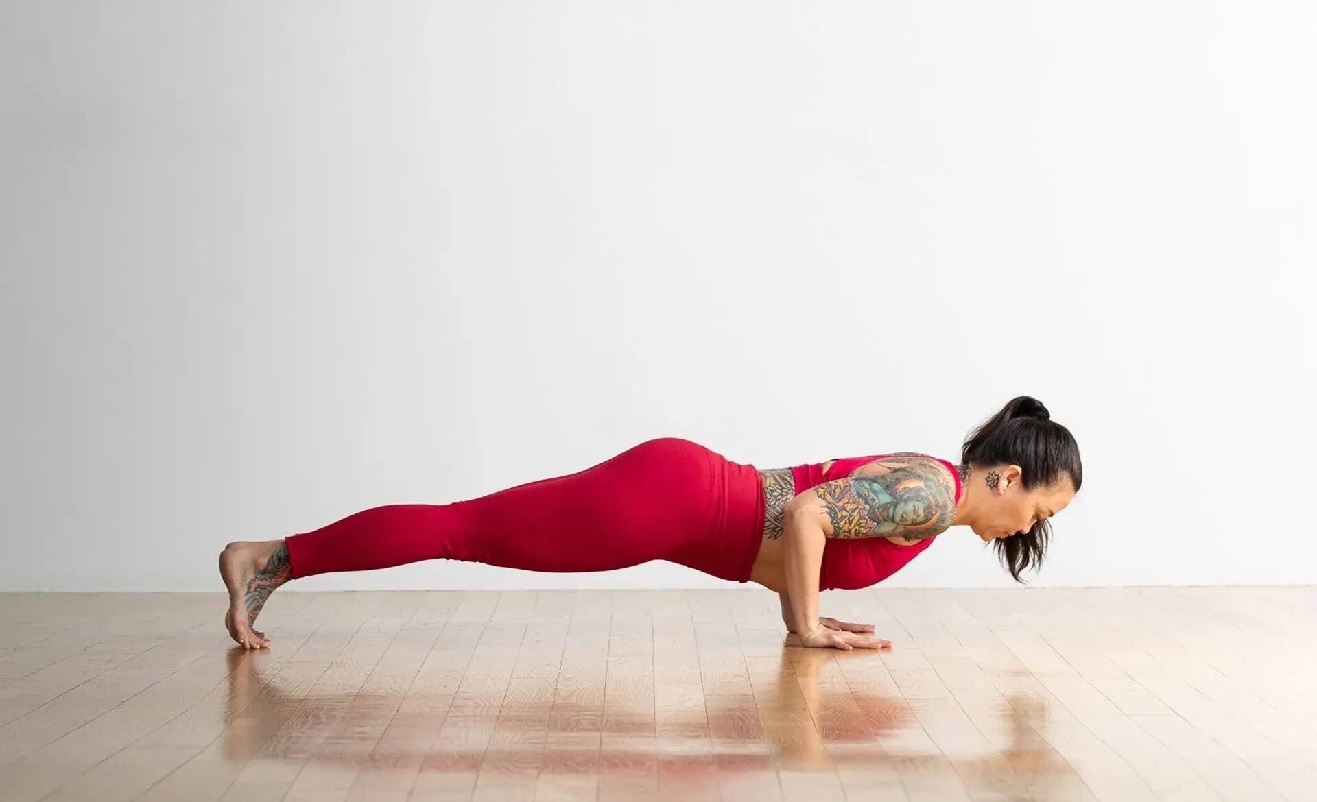 A woman in Four-Limbed Staff Pose, Chaturanga in Sanskrit