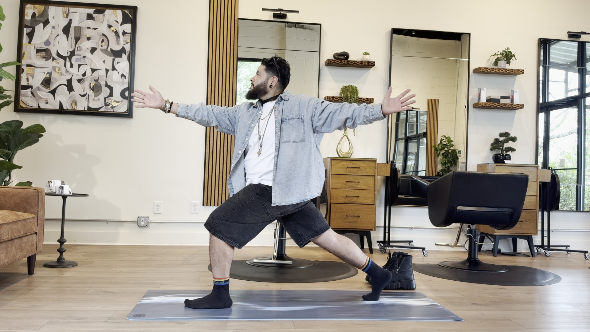 Yoga teacher practicing neck stretches in Crescent Lunge during a yoga after standing all day class