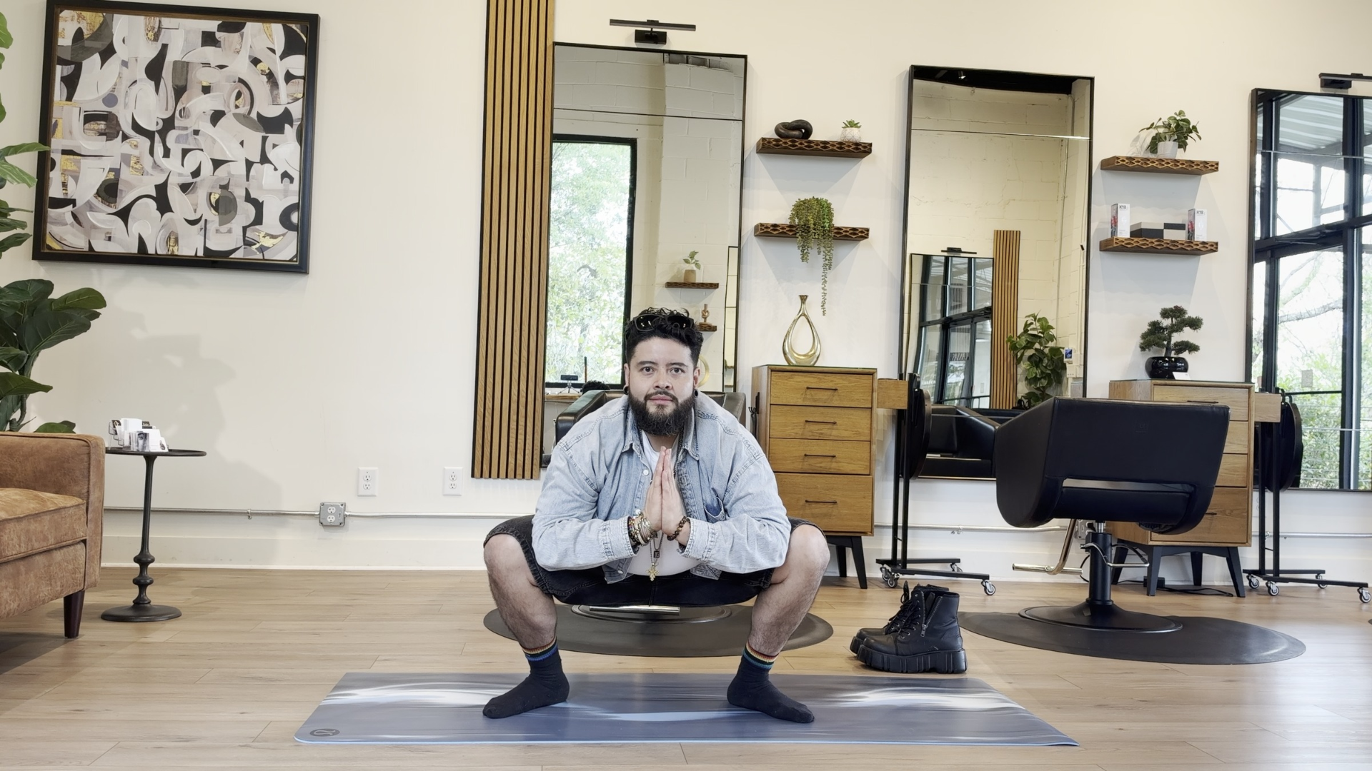 Yoga teacher practicing a yogi squat also known as Malasana.